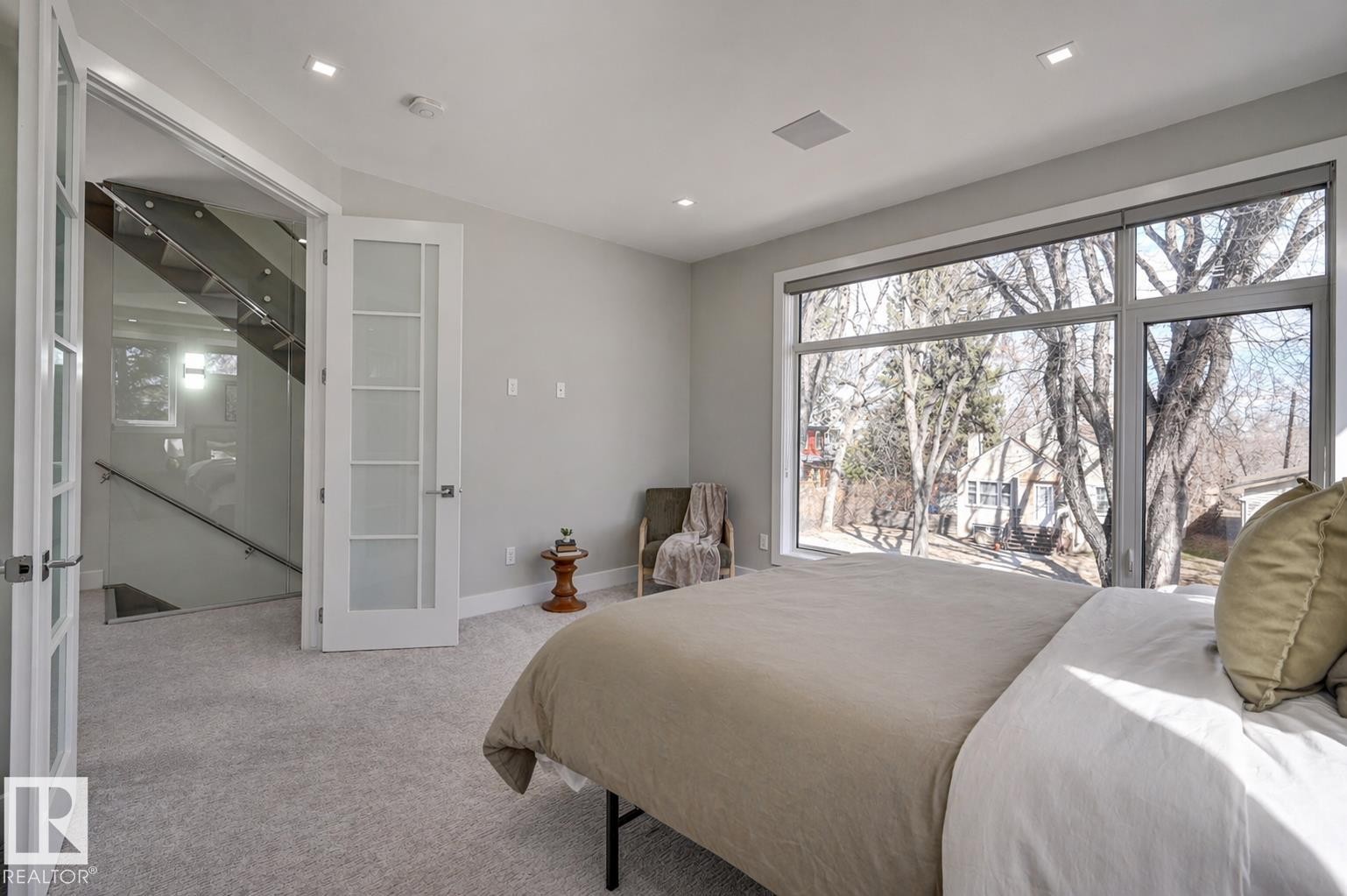 Bedroom featuring a large picture window, recessed lighting, and light-toned carpeting - 9741 90 Avenue, Edmonton, AB - Indoor Photo Showing Bedroom