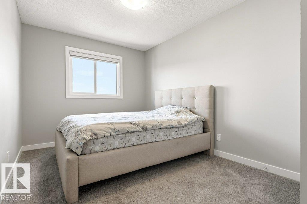 Neutral-toned room with light gray walls, white trim, and gray carpet flooring - 17451 77 Street, Edmonton, AB - Indoor Photo Showing Bedroom