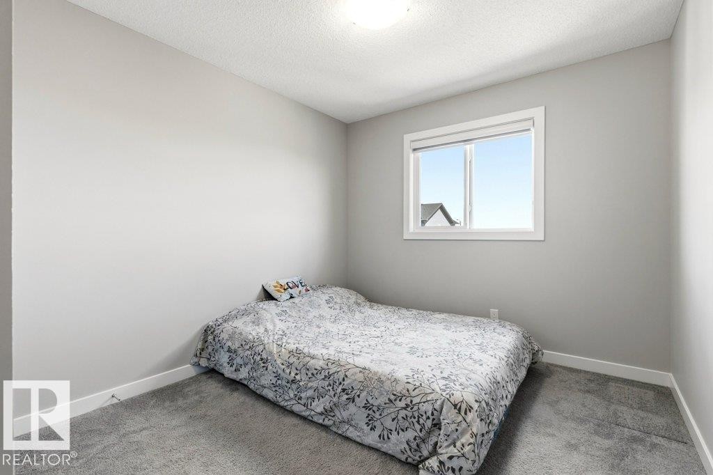 Neutral wall tones with a white trim package, featuring a window and recessed ceiling light - 17451 77 Street, Edmonton, AB - Indoor Photo Showing Bedroom