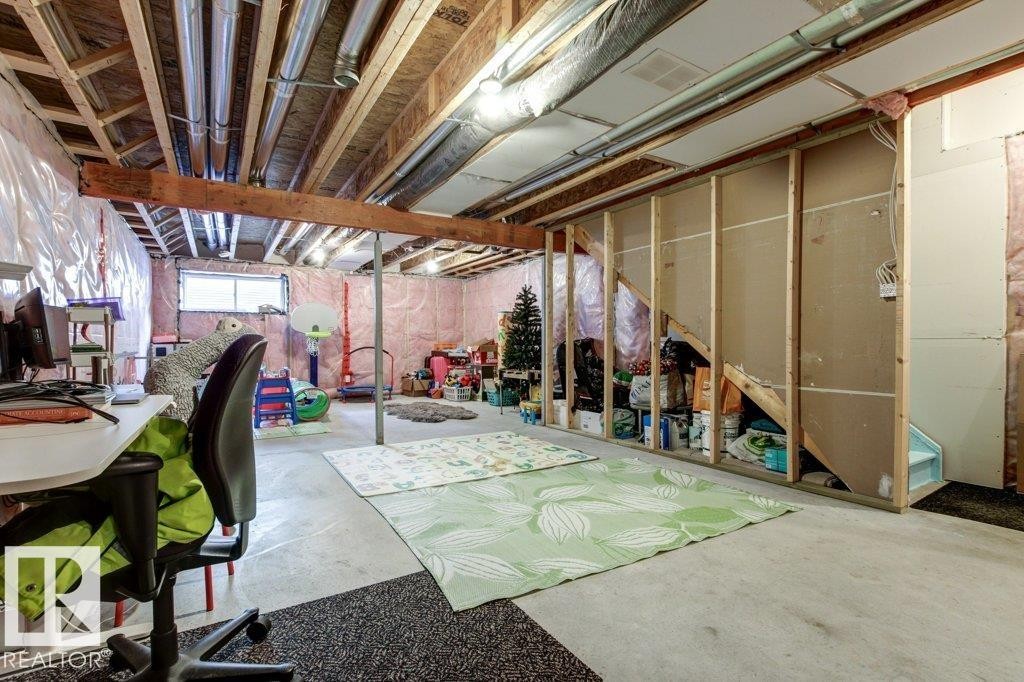 Unfinished basement with exposed ceiling joists and ductwork, featuring framed walls, concrete flooring, and a single window - 17451 77 Street, Edmonton, AB - Indoor Photo Showing Basement