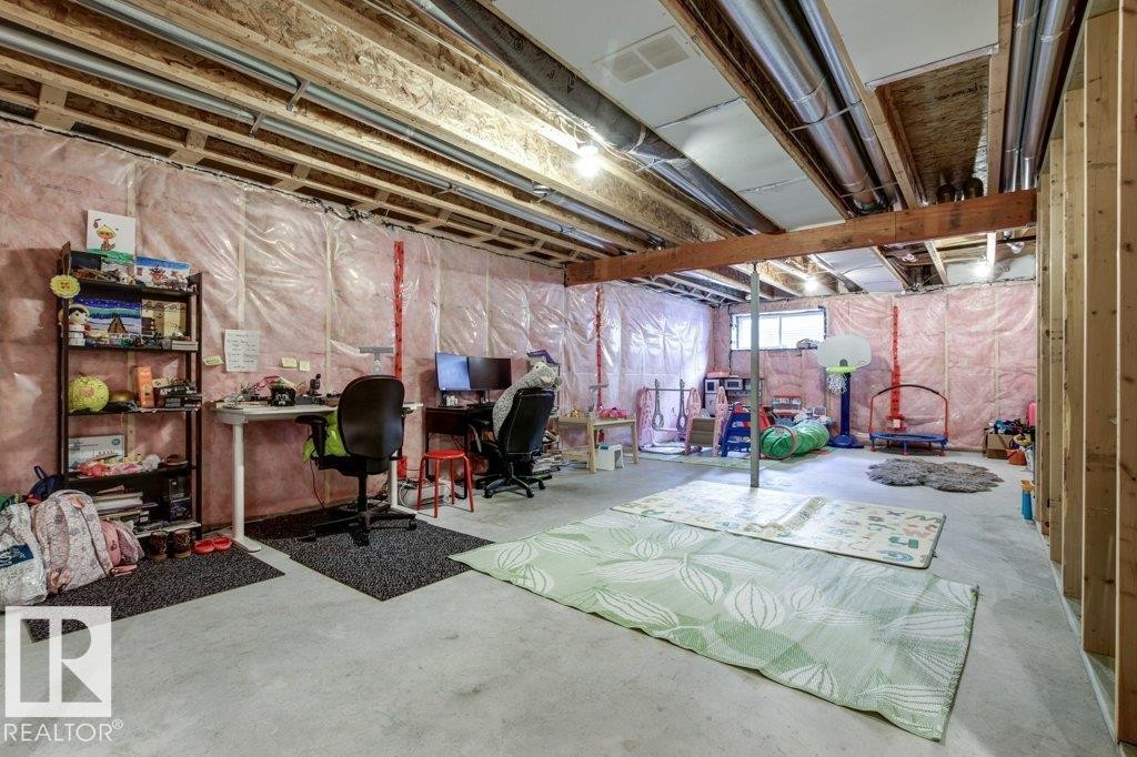 Unfinished basement with concrete flooring, exposed wood joists, and visible insulation - 17451 77 Street, Edmonton, AB - Indoor Photo Showing Basement