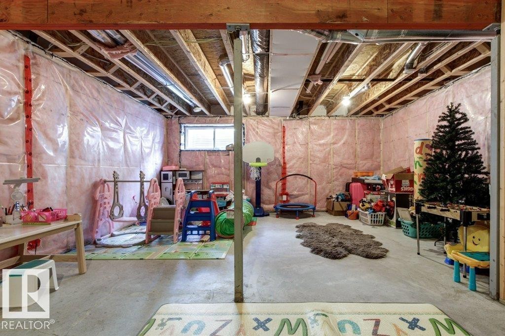 Unfinished basement featuring exposed wood joists, concrete flooring, insulated walls, and a small window - 17451 77 Street, Edmonton, AB - Indoor Photo Showing Basement