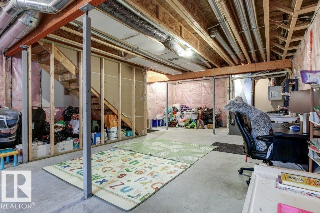 Unfinished basement featuring exposed wood joists and subflooring, concrete flooring, visible HVAC ductwork, and structural support beams - 17451 77 Street, Edmonton, AB - Indoor Photo Showing Basement