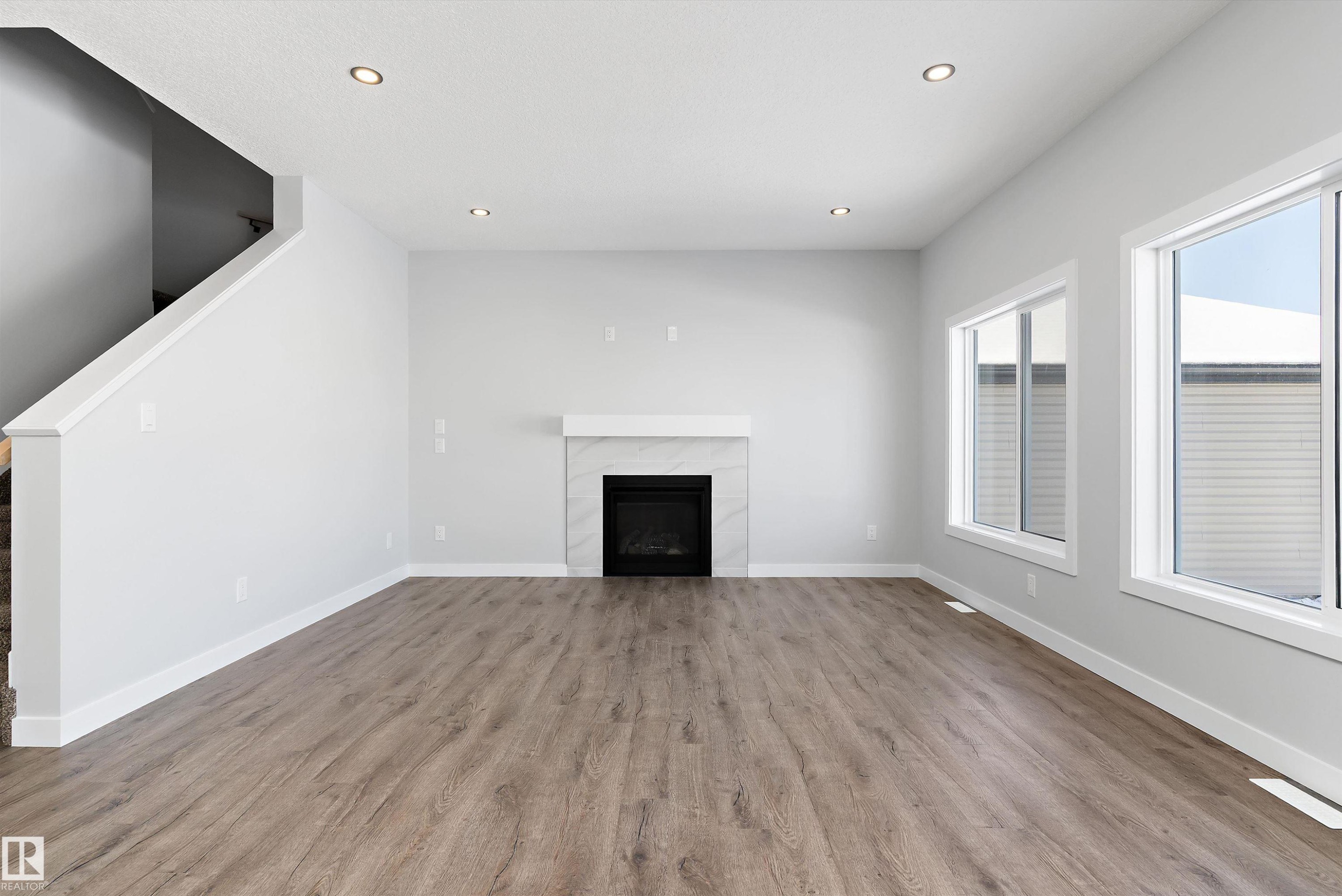 76 Maple Crescent, Gibbons, AB - Indoor Photo Showing Living Room With Fireplace