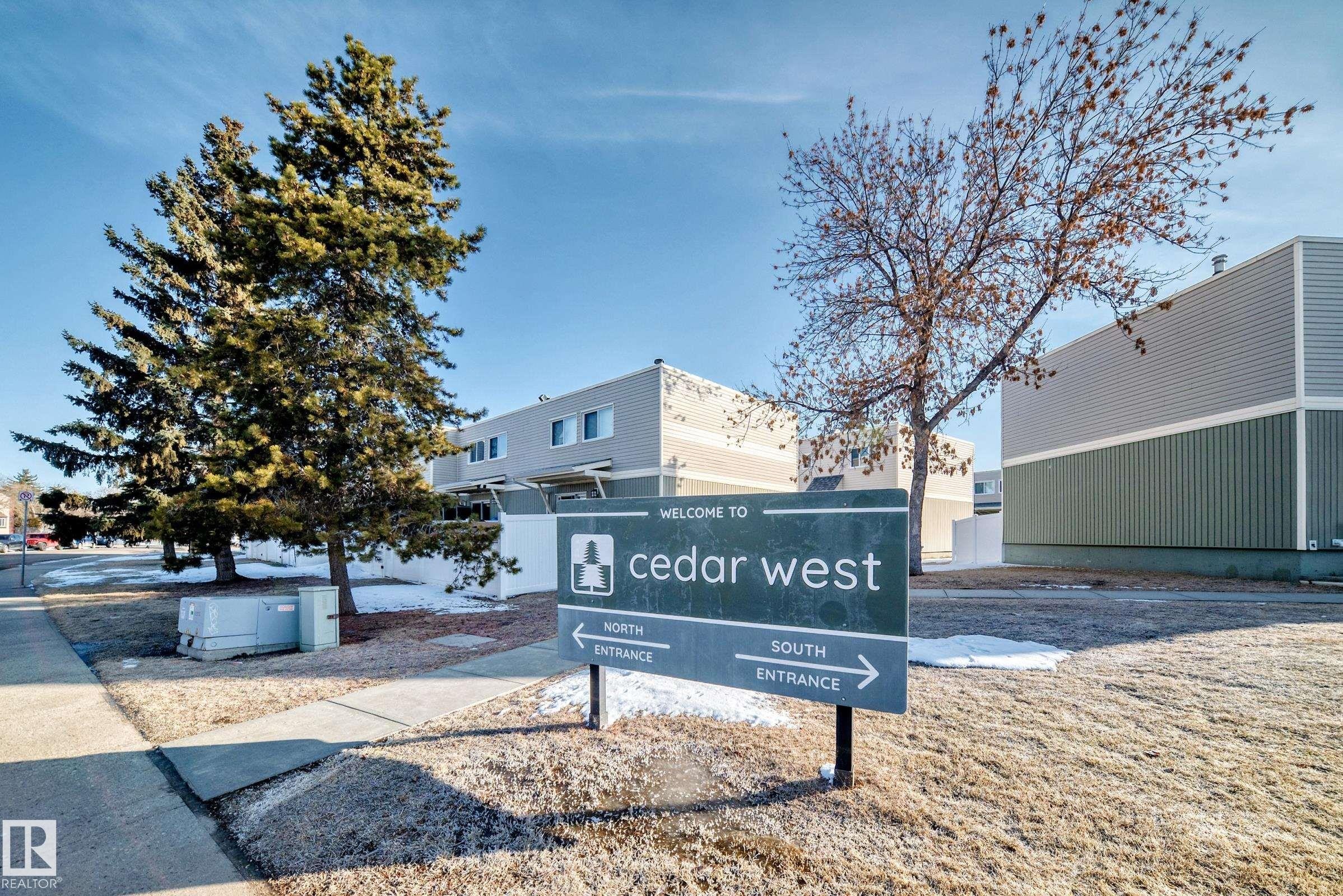 The property features a prominent sign for "Cedar West" with directional arrows for North and South entrances - 8217 182 Street Nw, Edmonton, AB - Outdoor