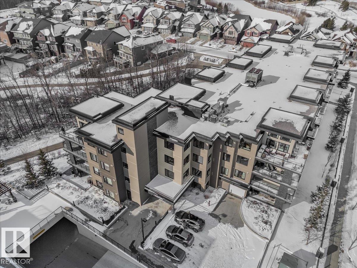 This property features a multi-story building with balconies and an underground parking garage - 211 5029 Edgemont Boulevard, Edmonton, AB -