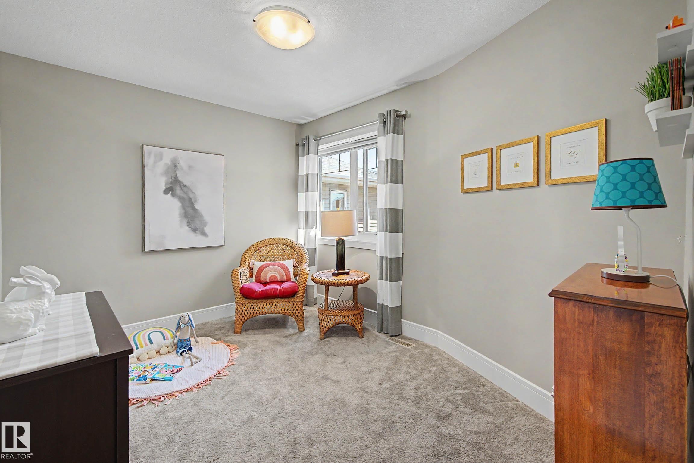 Carpeted room featuring light gray walls, white baseboards, and a window with white trim - 2086 Redtail Common, Edmonton, AB - Indoor