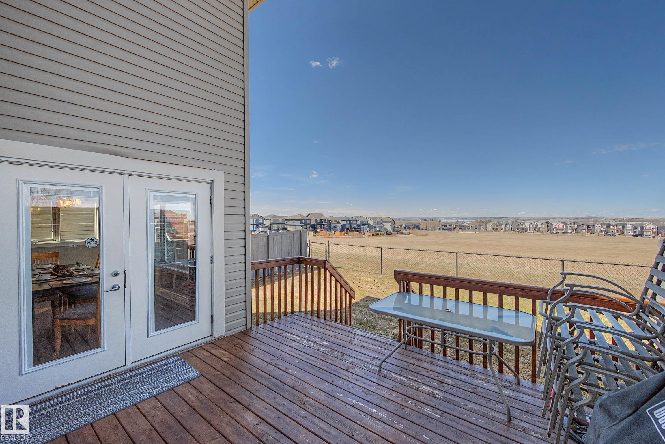 Exterior wood deck featuring a wooden railing and stairs - 2086 Redtail Common, Edmonton, AB - Outdoor With Deck Patio Veranda With Exterior