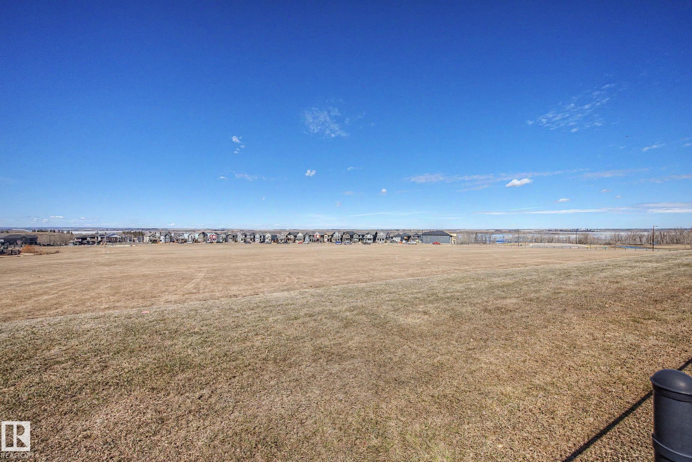 Expansive open field with a clear blue sky overhead - 2086 Redtail Common, Edmonton, AB - Outdoor With View