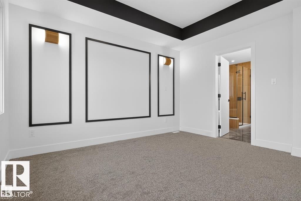 Spacious room featuring broadloom carpeting and a tray ceiling with a black accent trim - 55 Rosa Crescent, St. Albert, AB - Indoor Photo Showing Other Room