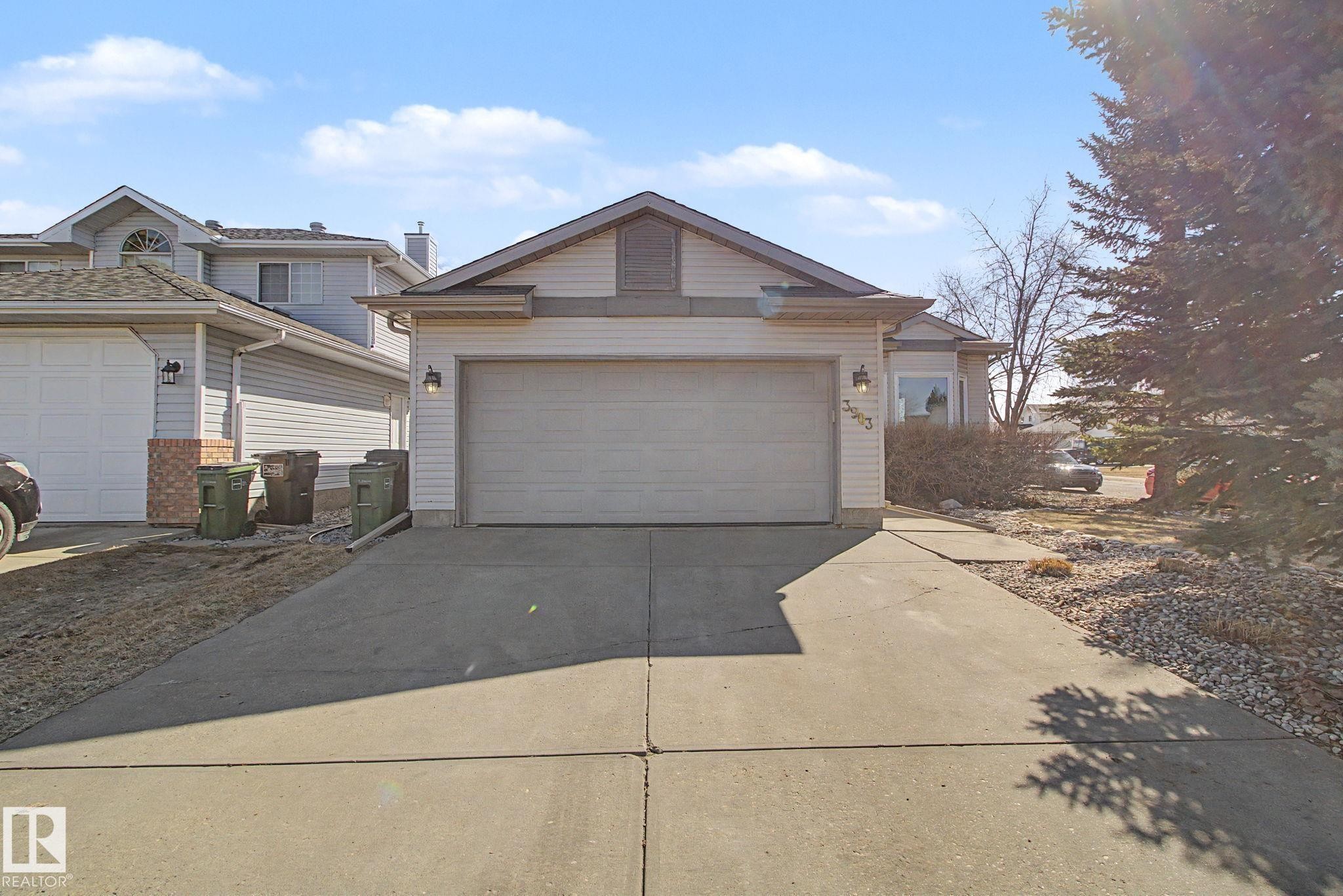 Single-story residence featuring light-colored siding, an attached garage, and a concrete driveway - 3903 32 Street, Edmonton, AB - Outdoor