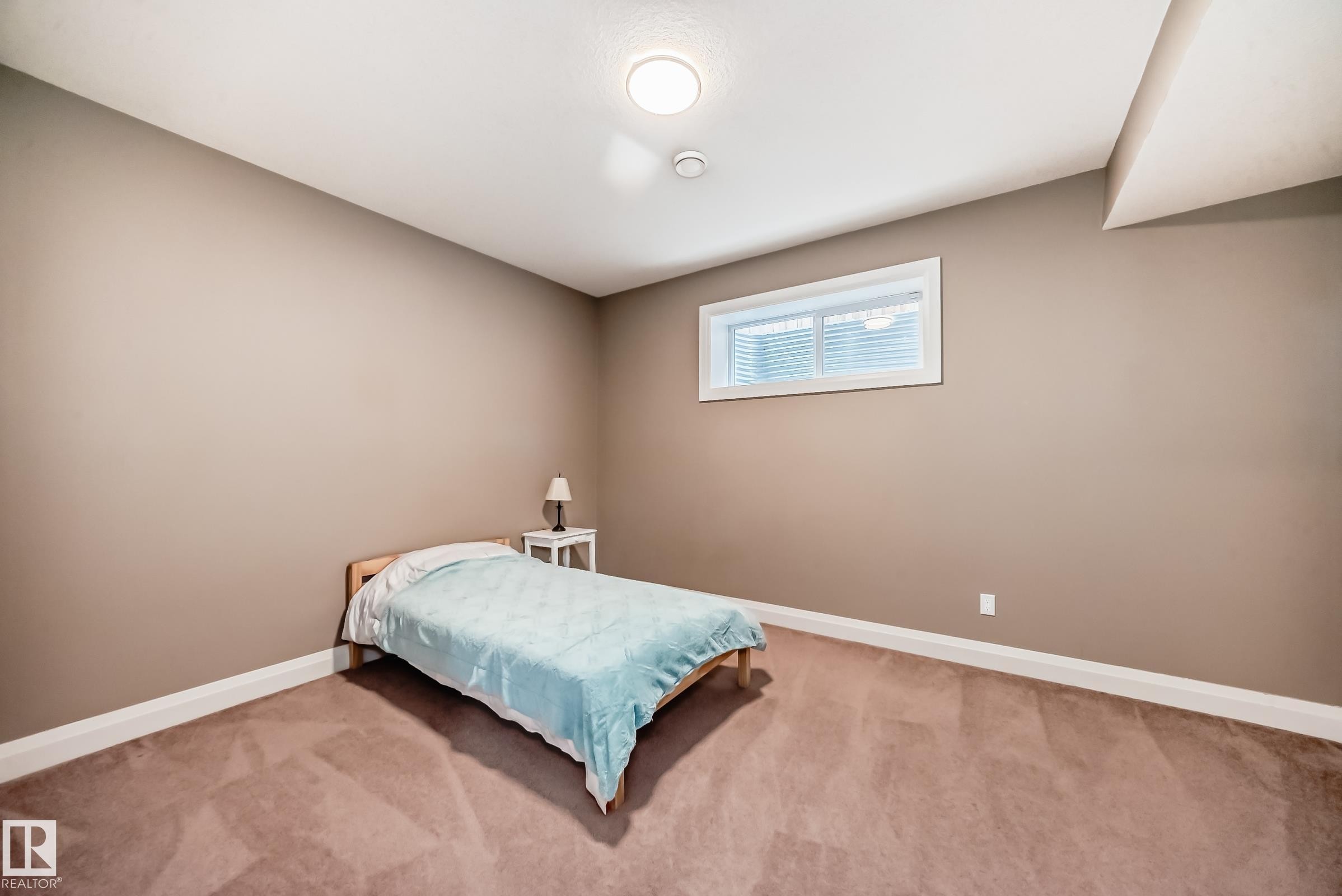 Room featuring neutral colored walls, brown carpet, and a window with blinds - 3220 151 Avenue, Edmonton, AB - Indoor