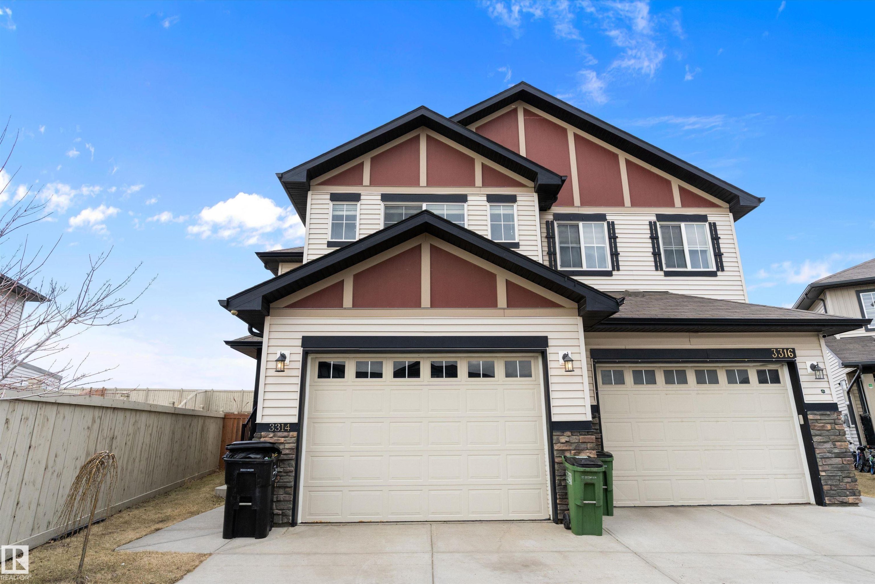 Two-story residence featuring light-colored siding with dark trim accents - 3314 9 Street Nw, Edmonton, AB - Outdoor