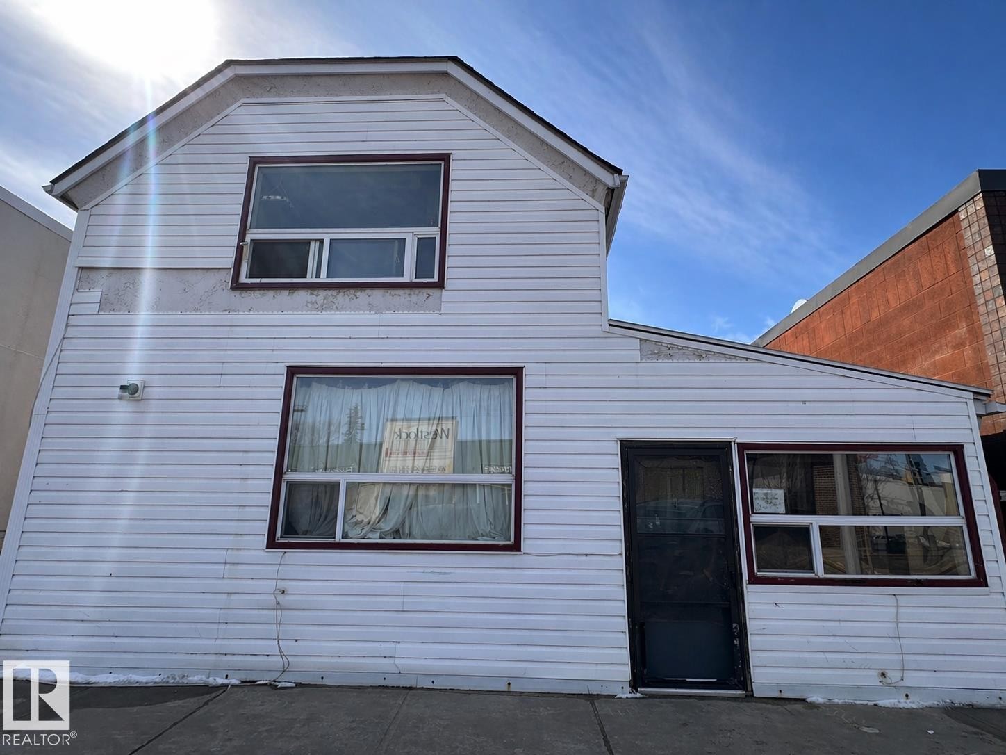 Two-story structure featuring white horizontal siding and maroon window trim - 10528 100 Avenue, Westlock, AB - Outdoor With Exterior
