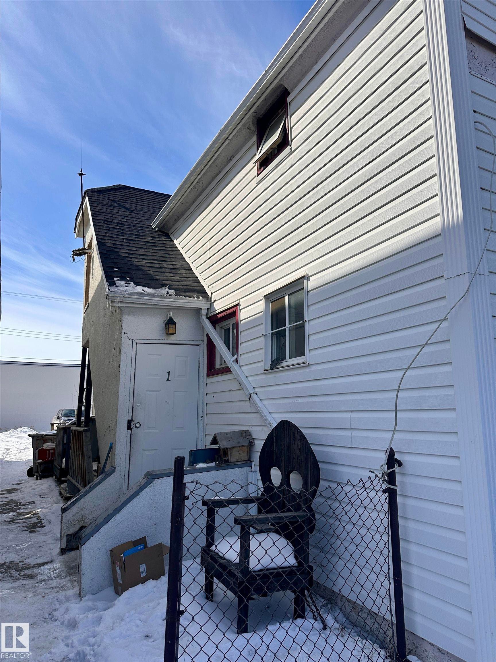 White vinyl siding exterior with a contrasting dark shingle roof - 10528 100 Avenue, Westlock, AB - Outdoor With Exterior
