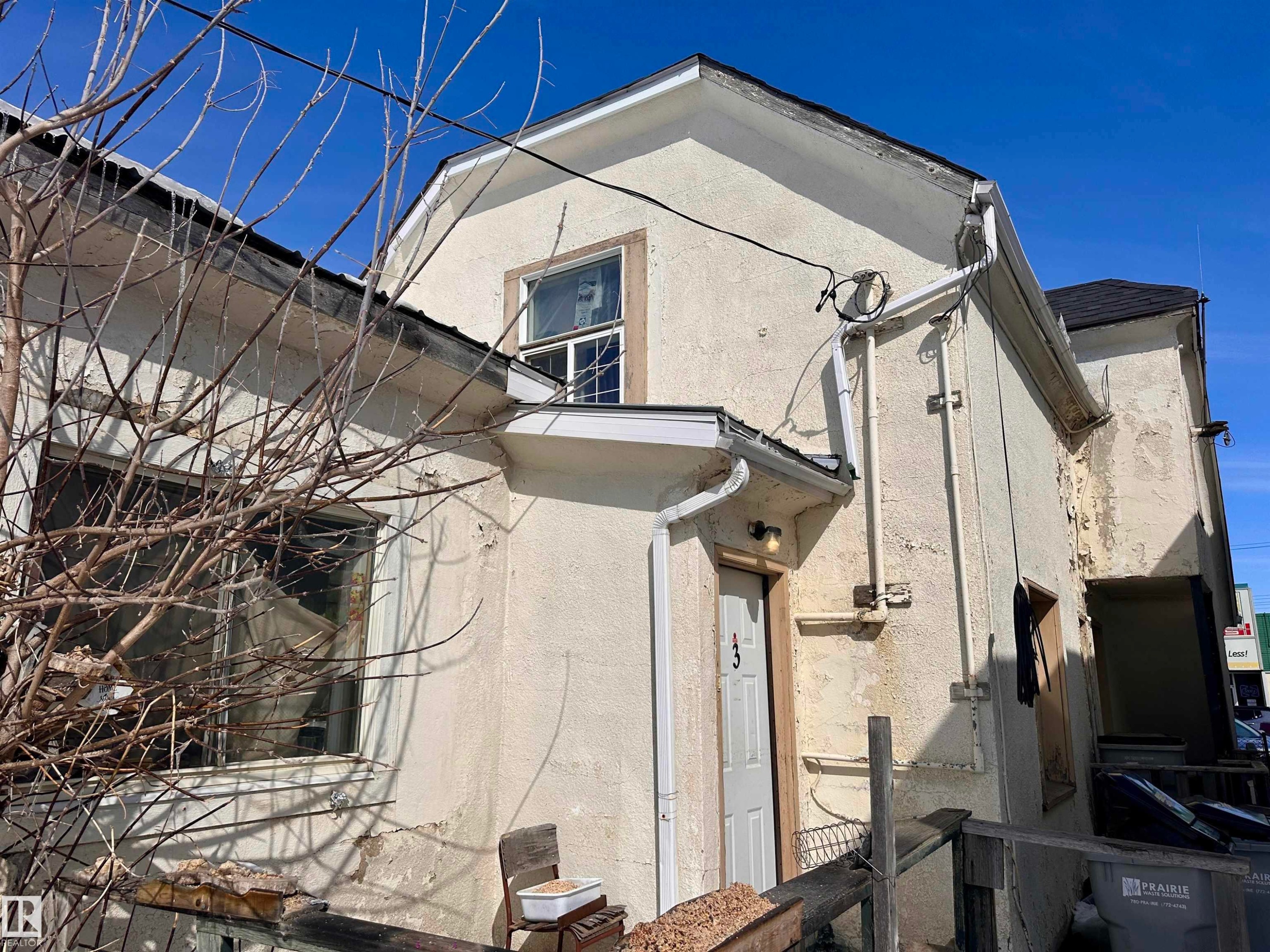 Stucco exterior with multiple windows - 10528 100 Avenue, Westlock, AB - Outdoor