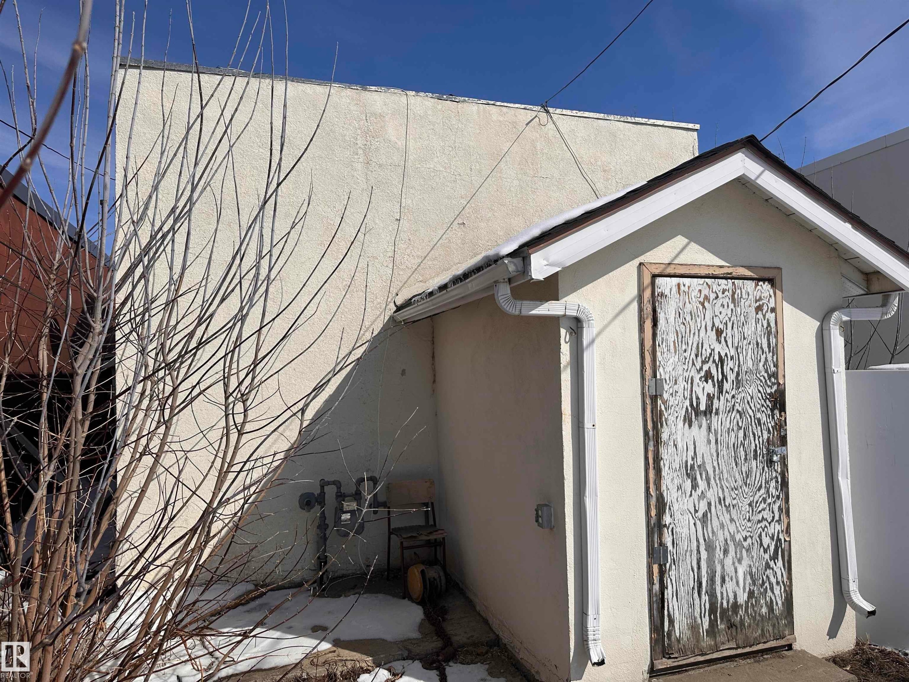 Exterior featuring a detached structure with a gable roofline and white gutters - 10528 100 Avenue, Westlock, AB -