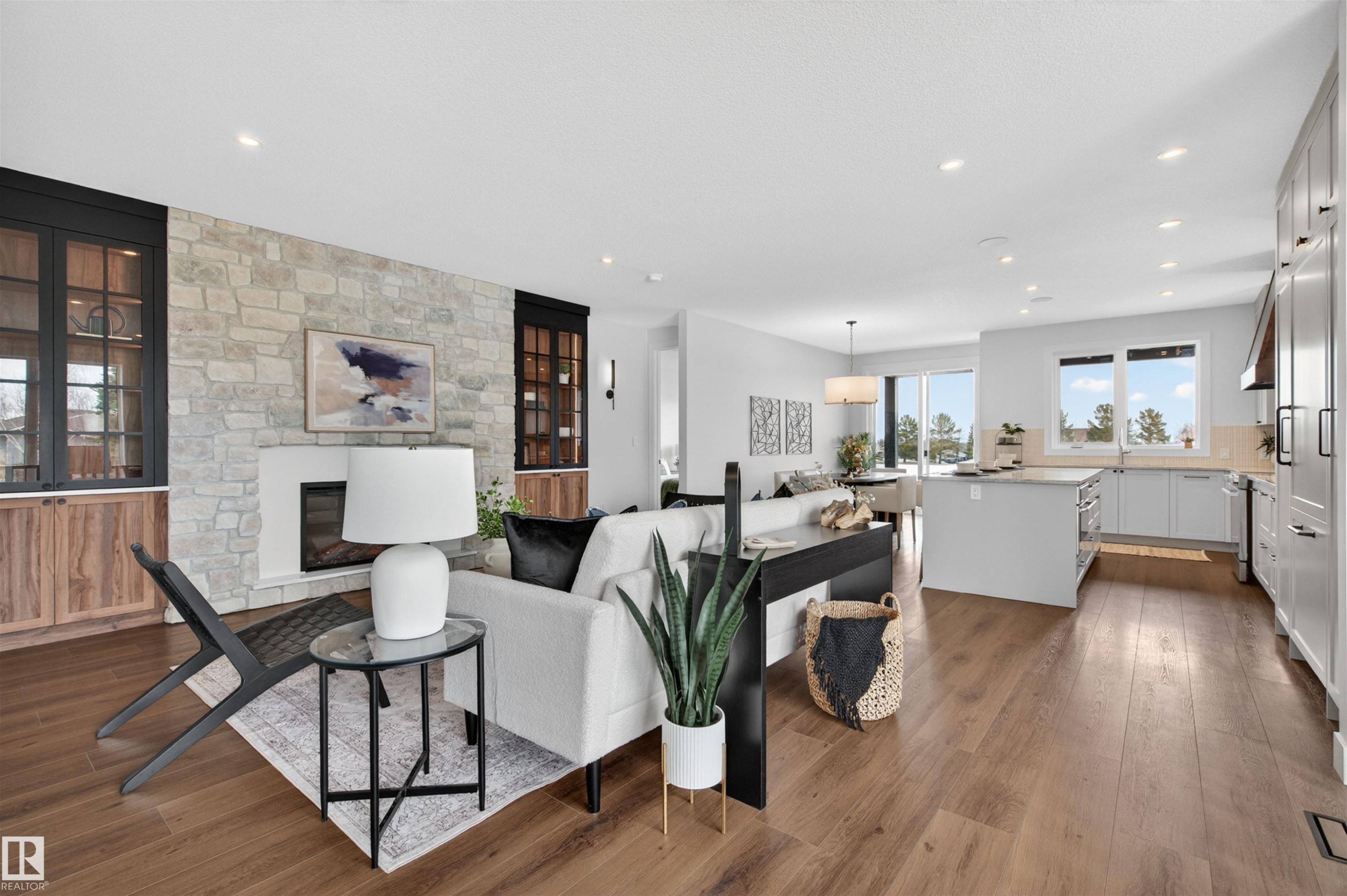 Open-concept living space with wood-finish flooring throughout - 149 Eastgate Way, St. Albert, AB - Indoor