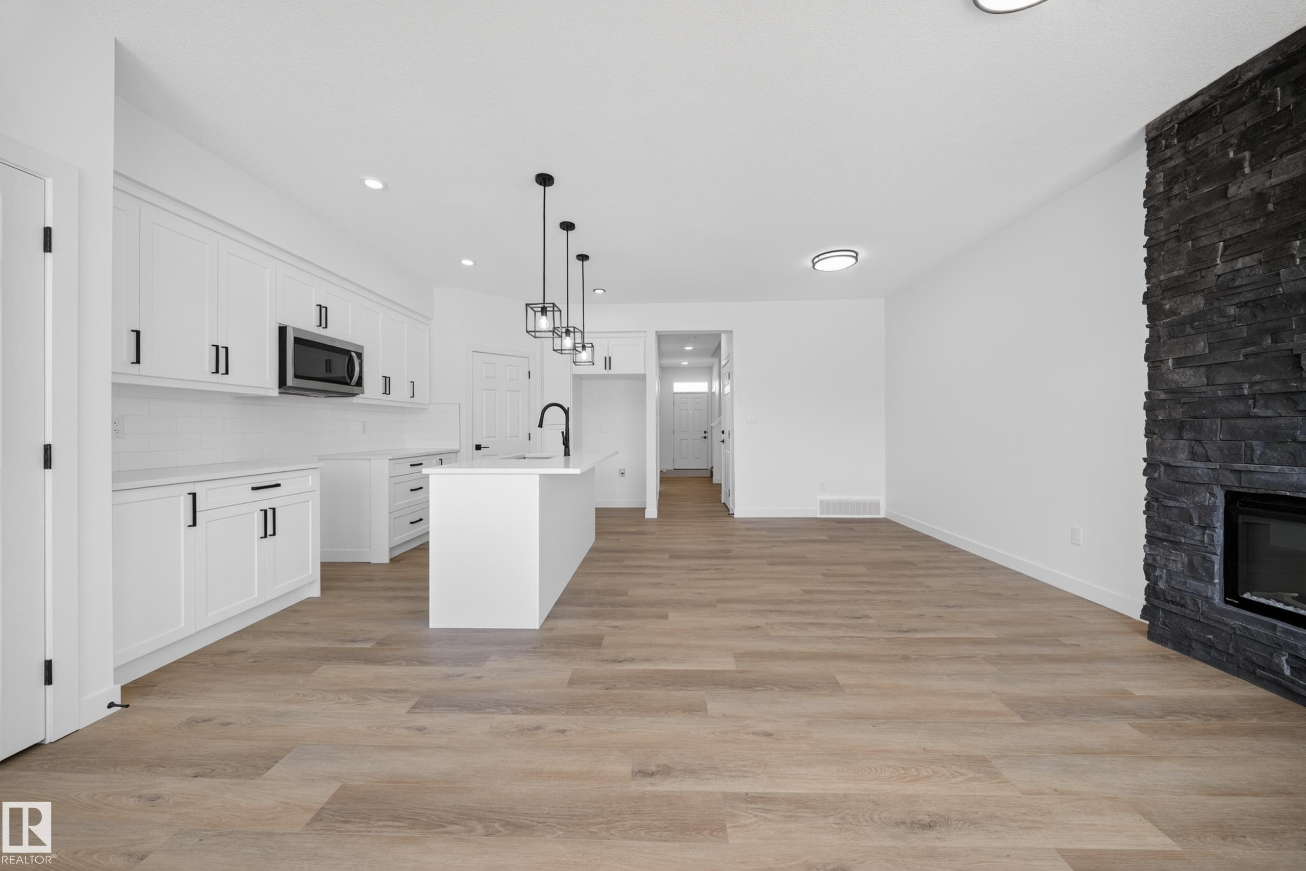 227 Deer Valley Drive, Leduc, AB - Indoor Photo Showing Kitchen With Fireplace