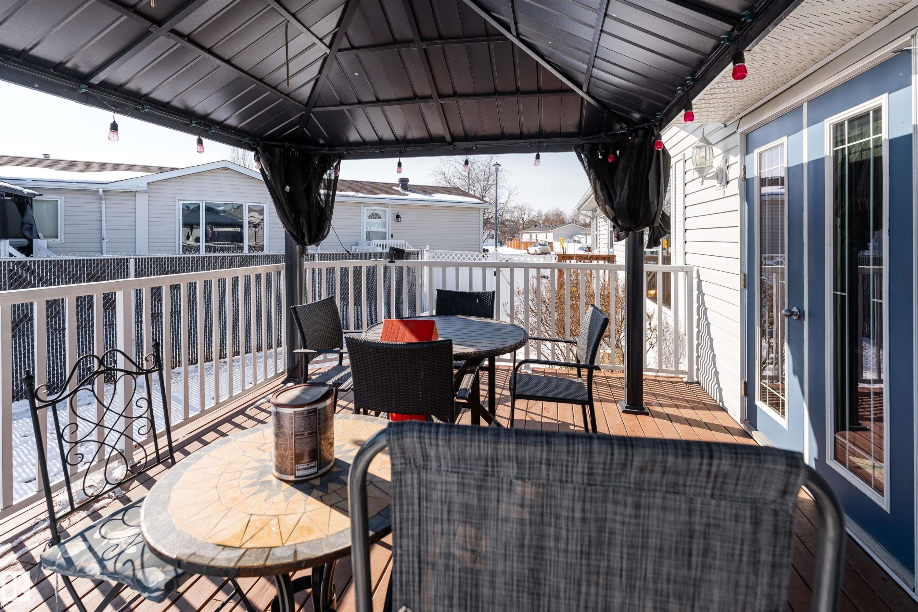 The property features a spacious deck with wood-look plank flooring and a white railing - 1663 Jubilee Crescent, Sherwood Park, AB - Outdoor With Deck Patio Veranda With Exterior