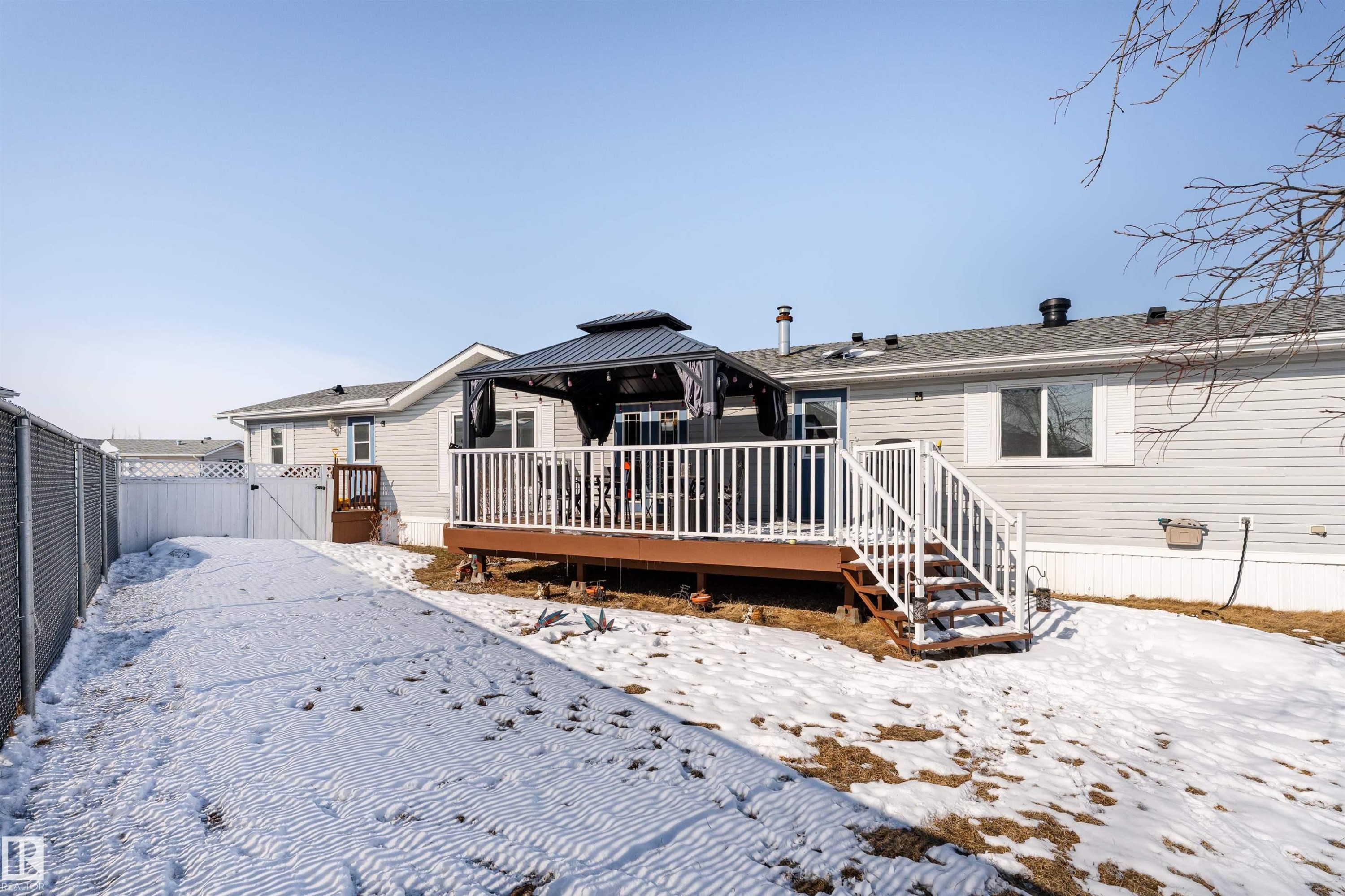 The property features a spacious rear deck with white railings and an outdoor gazebo, offering an inviting area for enjoyment - 1663 Jubilee Crescent, Sherwood Park, AB - Outdoor With Deck Patio Veranda