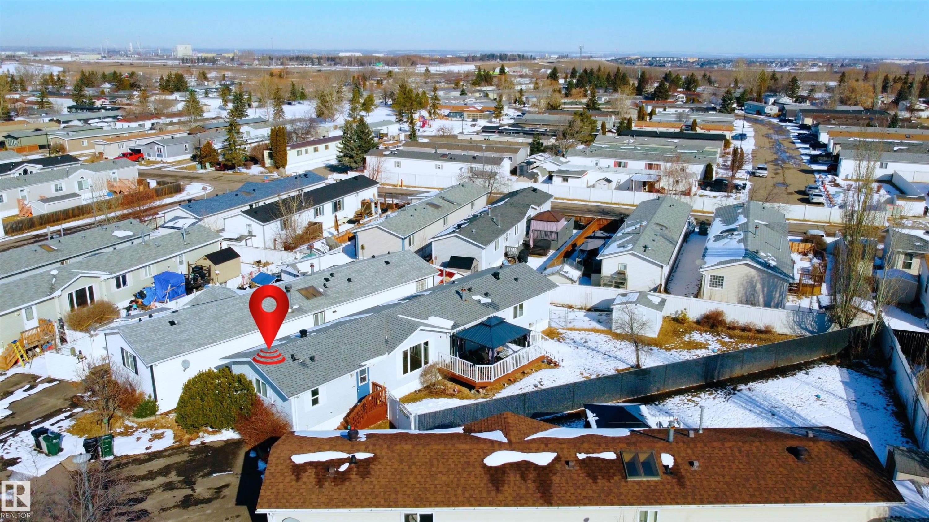 Aerial view showcasing the property with a light-colored exterior and a covered deck, situated within a community of residences - 1663 Jubilee Crescent, Sherwood Park, AB - Outdoor With View
