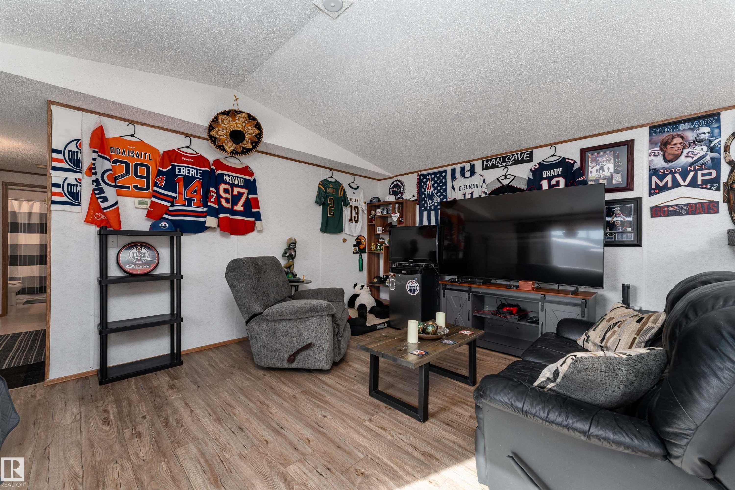 Living area featuring wood-look flooring and a vaulted ceiling - 1663 Jubilee Crescent, Sherwood Park, AB - Indoor