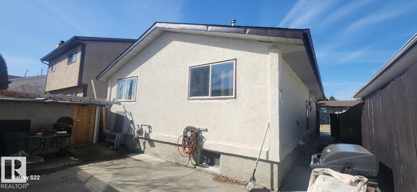 Stucco exterior with brown trim details and white-framed windows - 14411 31 Street, Edmonton, AB - Outdoor With Exterior