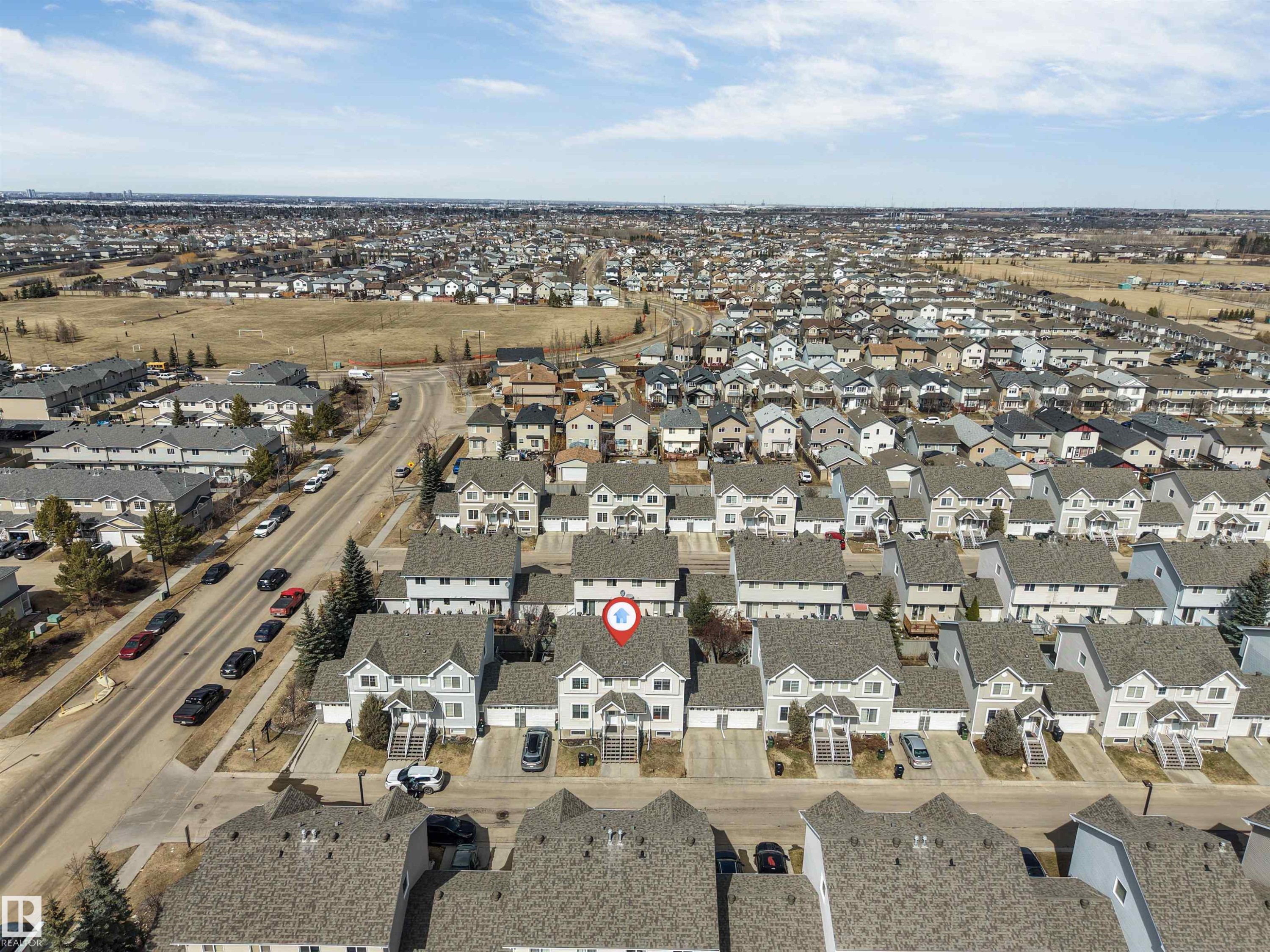 Aerial perspective showcasing a residential community with a consistent architectural style - 48 2503 24 Street, Edmonton, AB - Outdoor With View