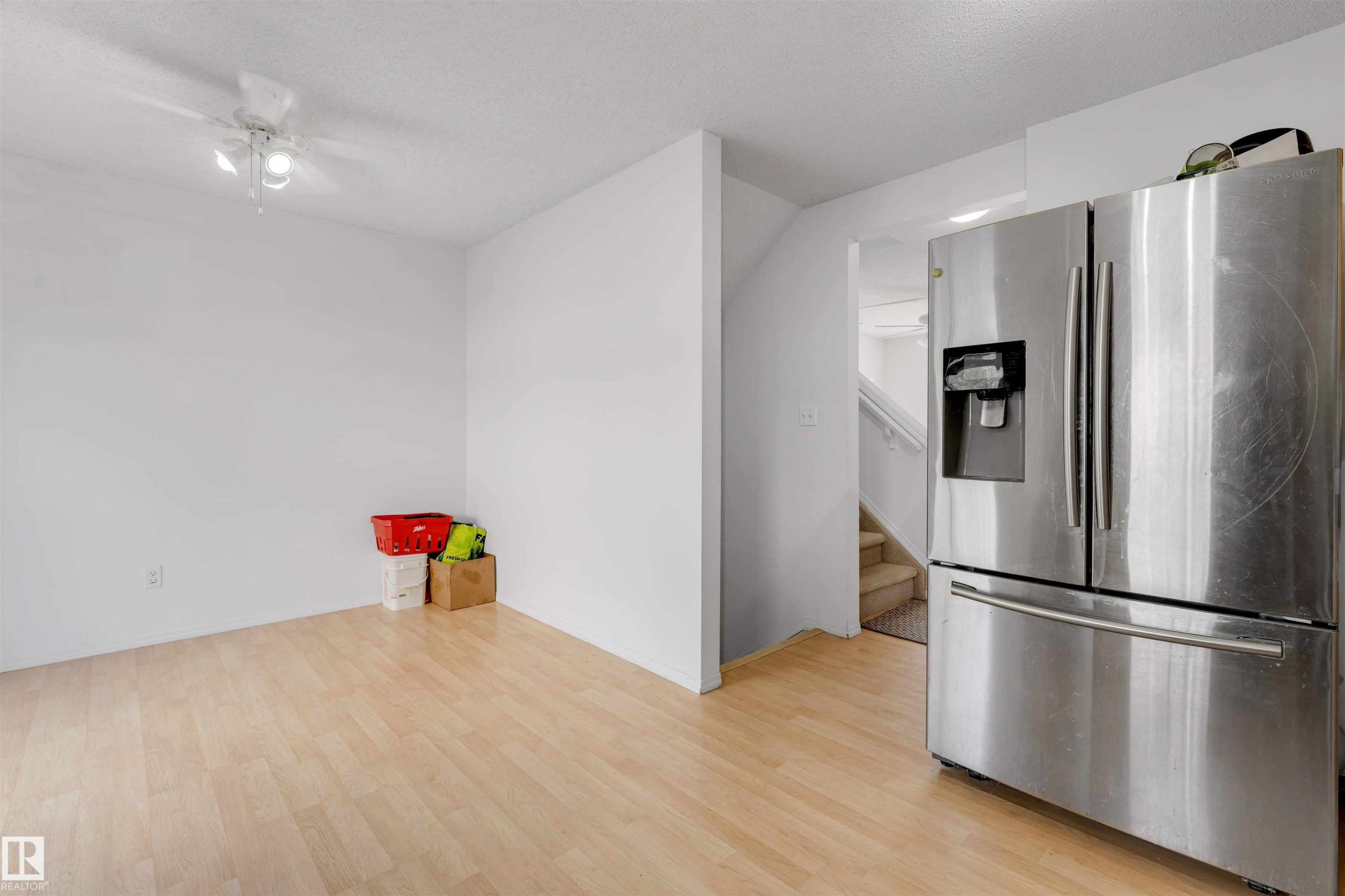 Open-concept room featuring light wood-finish flooring and a ceiling fan - 48 2503 24 Street, Edmonton, AB - Indoor