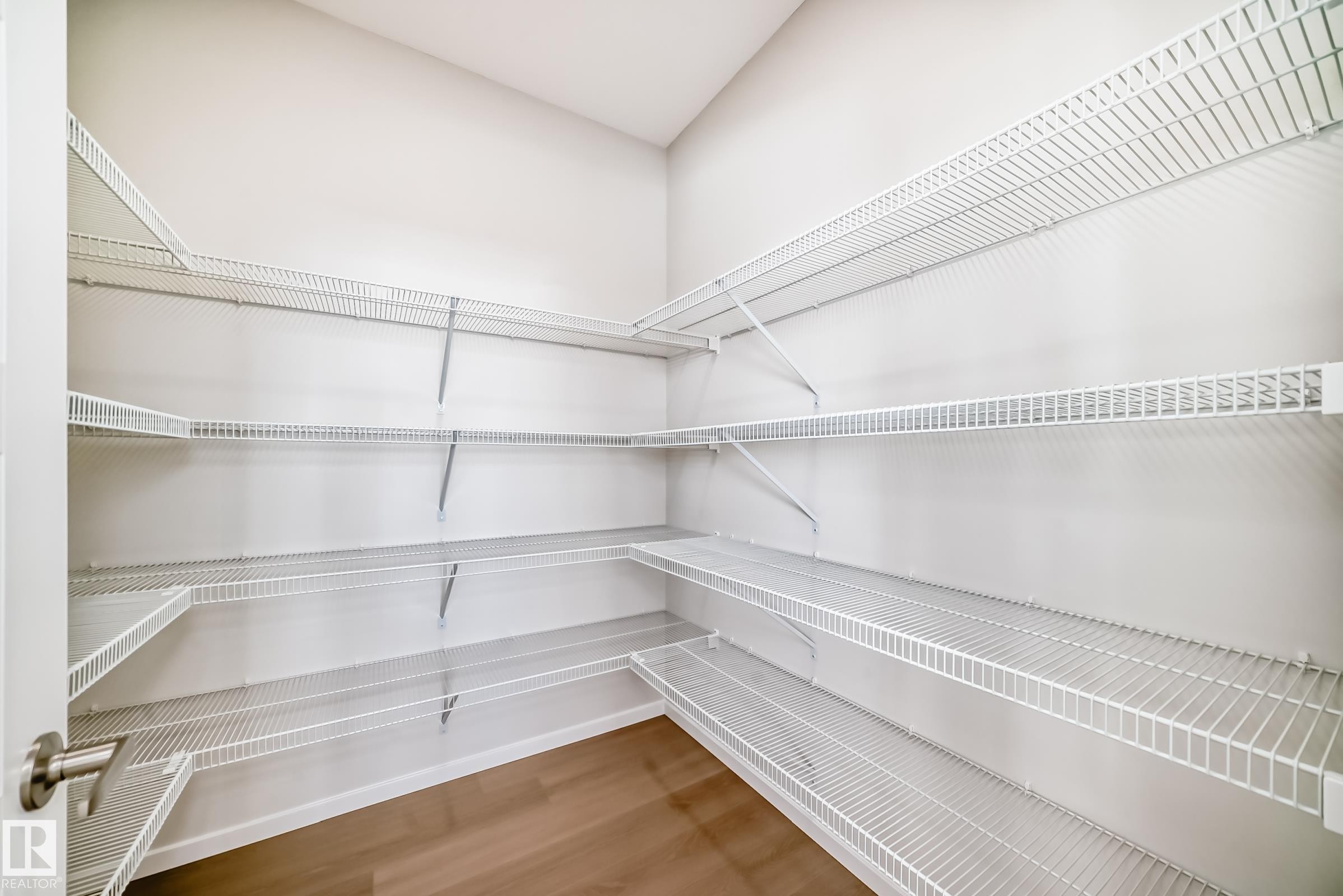 Spacious closet featuring white wire shelving and light-toned flooring - 1516 206 Street Nw, Edmonton, AB - Indoor With Storage