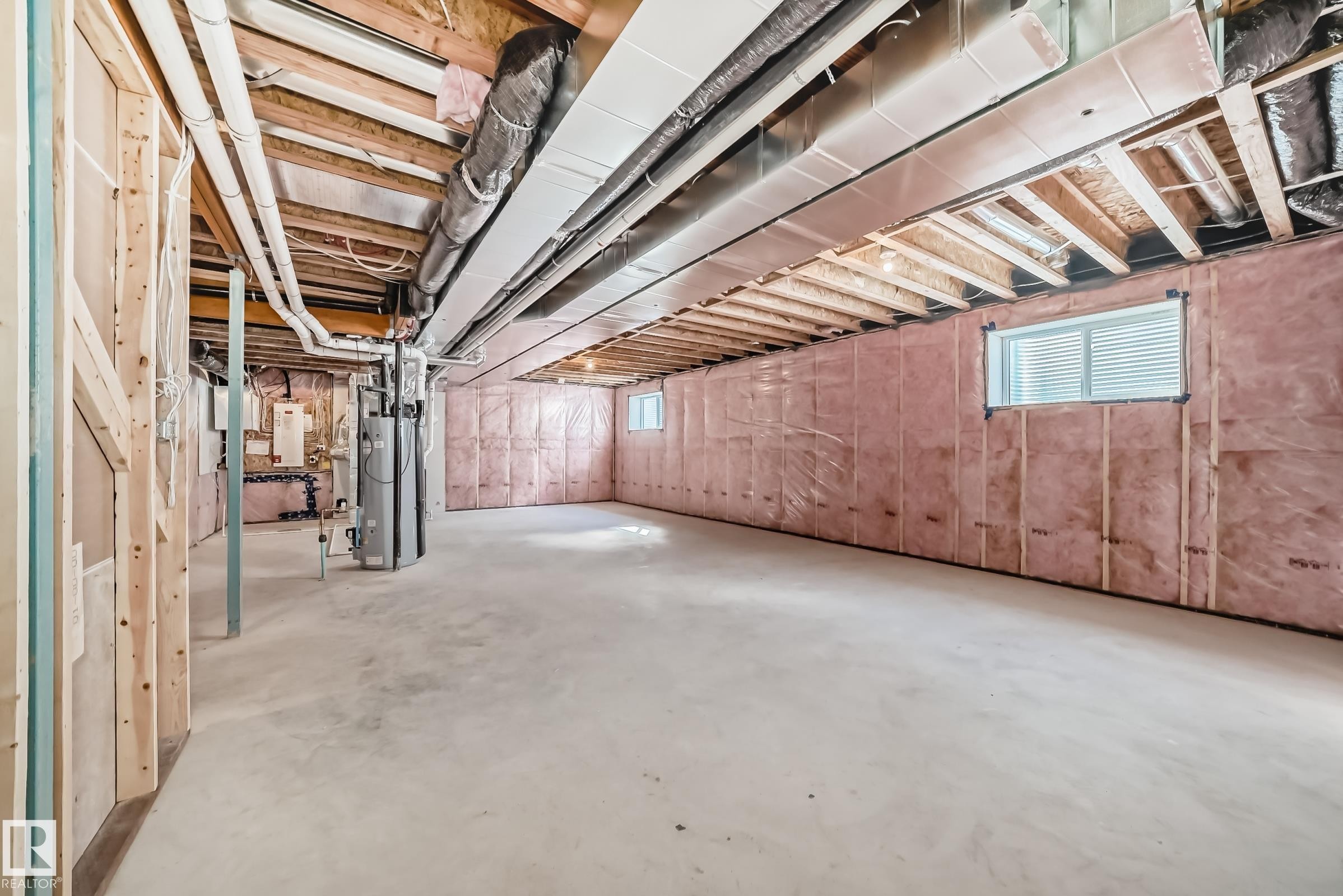 The property features an unfinished basement with exposed wooden beams, insulation, and concrete flooring - 1516 206 Street Nw, Edmonton, AB - Indoor Photo Showing Basement