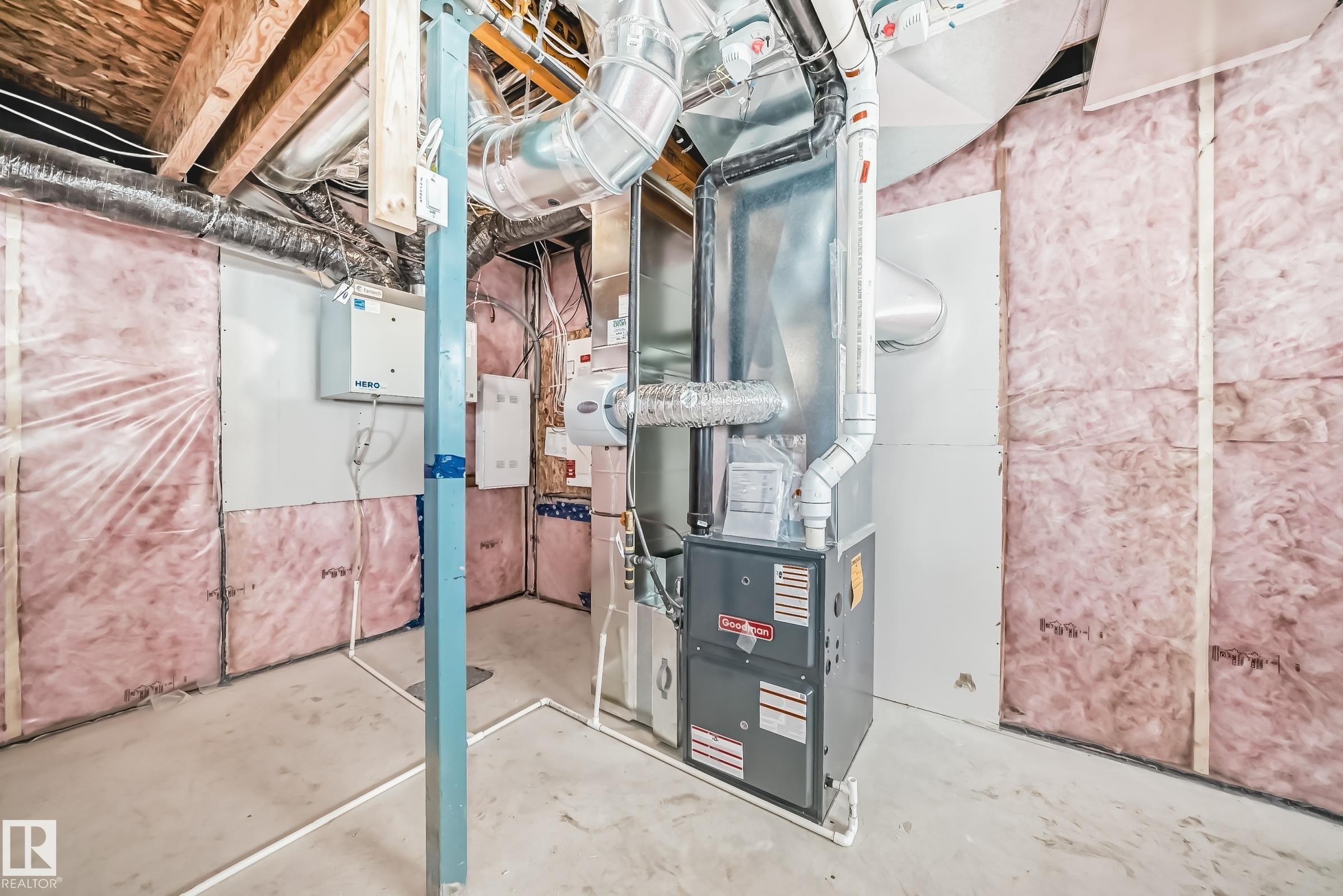The property features a furnace and exposed ductwork, alongside insulation and exposed wooden ceiling joists - 1516 206 Street Nw, Edmonton, AB - Indoor Photo Showing Basement