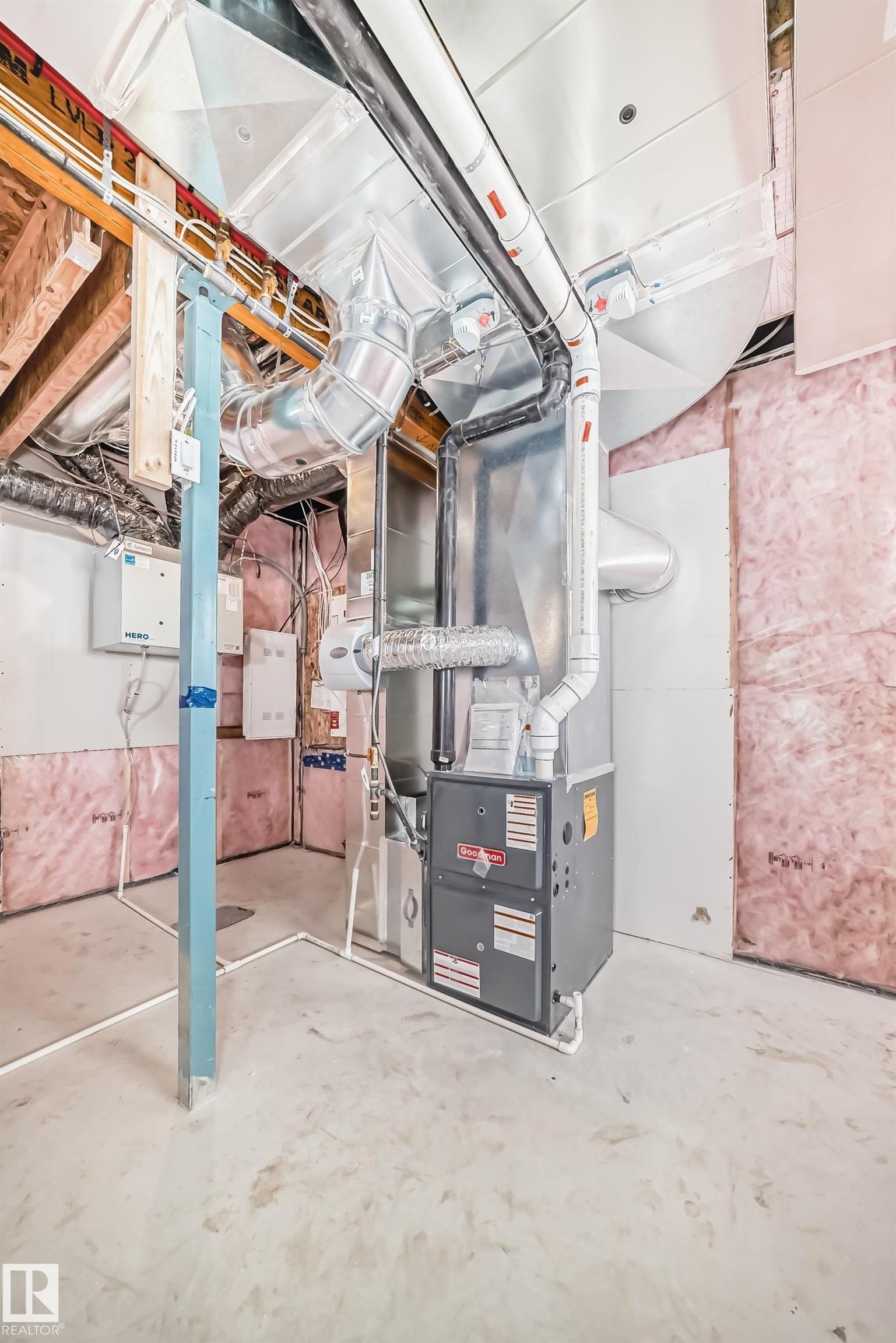 The property features a utility room with a furnace unit, exposed ceiling ductwork, and partially insulated walls - 1516 206 Street Nw, Edmonton, AB - Indoor Photo Showing Basement