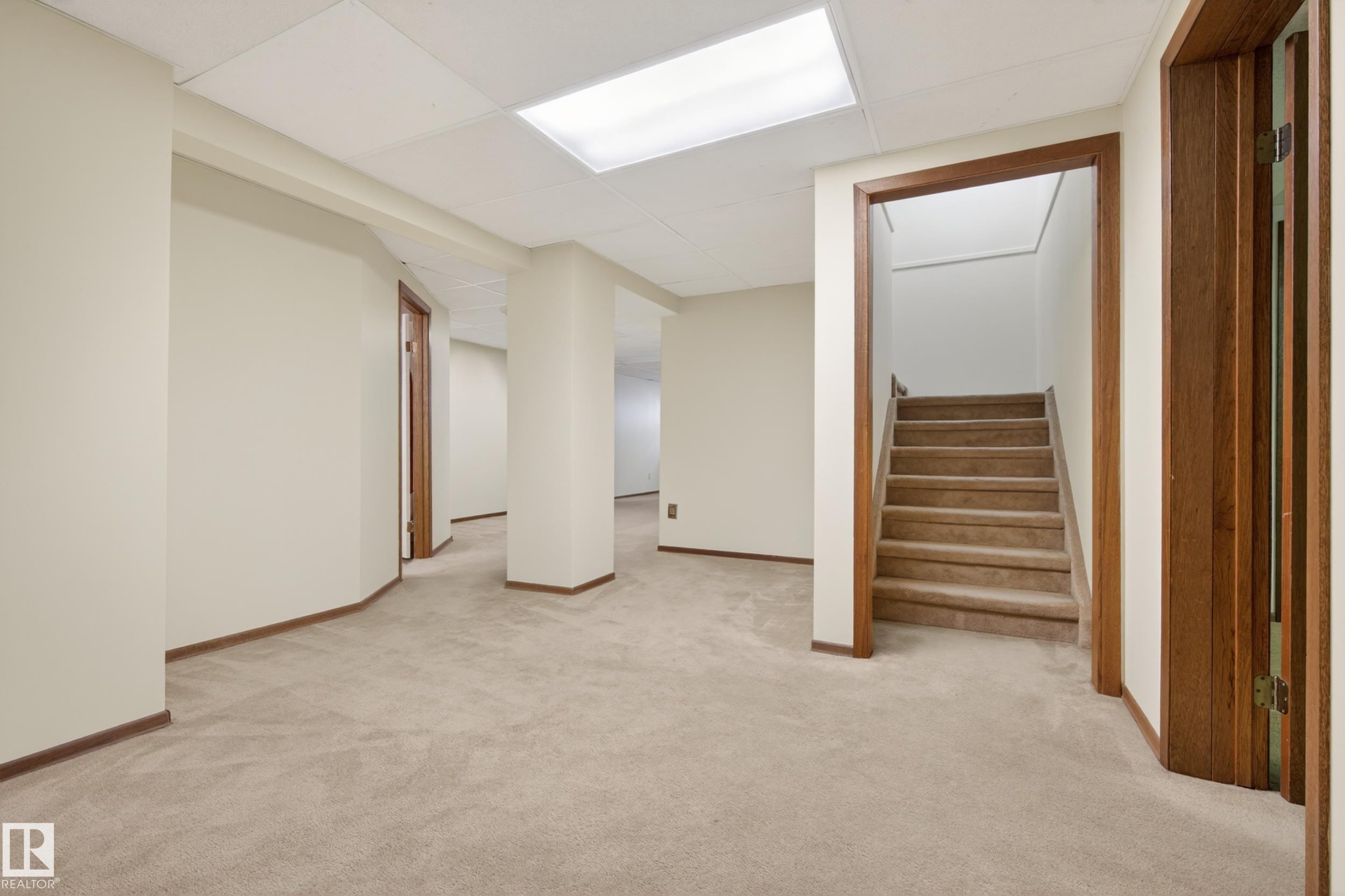 Versatile lower level with neutral carpet flooring and light beige walls - 33 Glen Meadow Crescent, St. Albert, AB - Indoor Photo Showing Other Room
