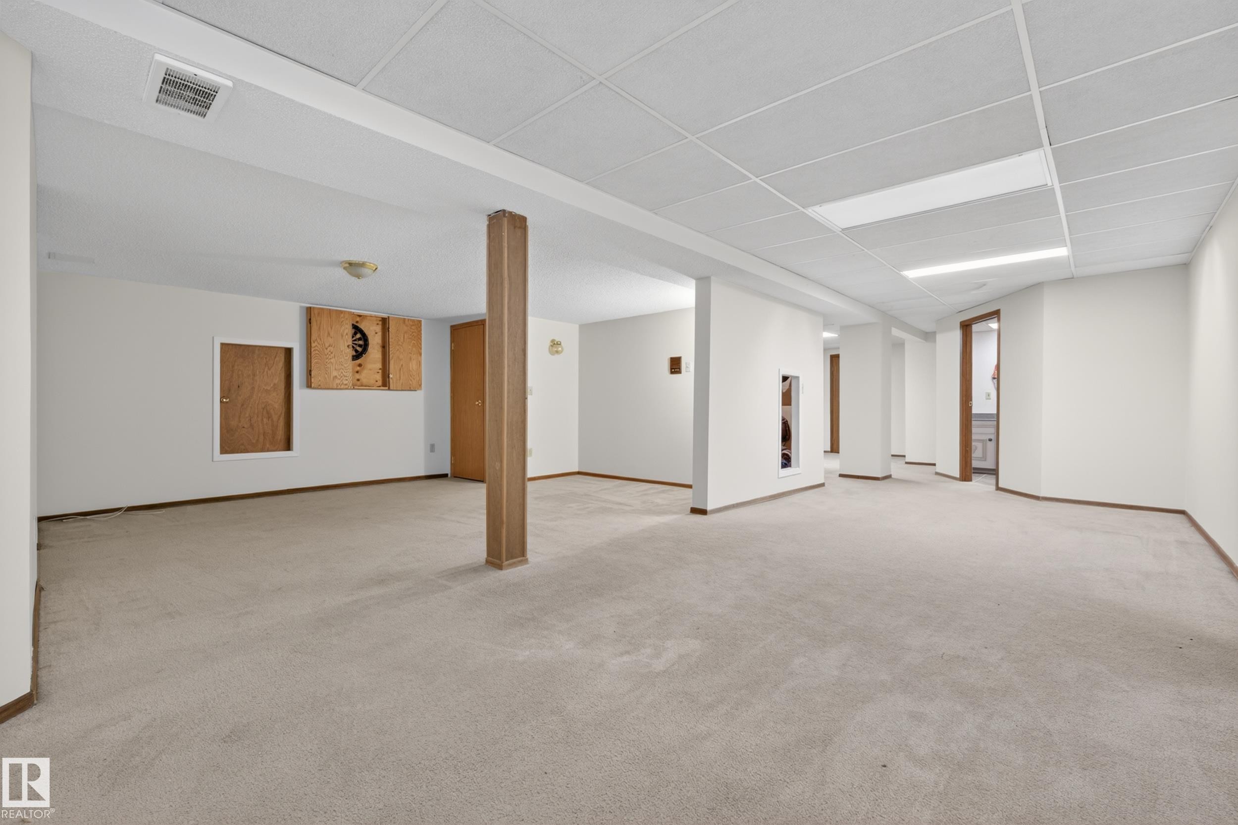 Spacious lower level featuring light-toned carpeting, white walls, and a dropped acoustic ceiling - 33 Glen Meadow Crescent, St. Albert, AB - Indoor