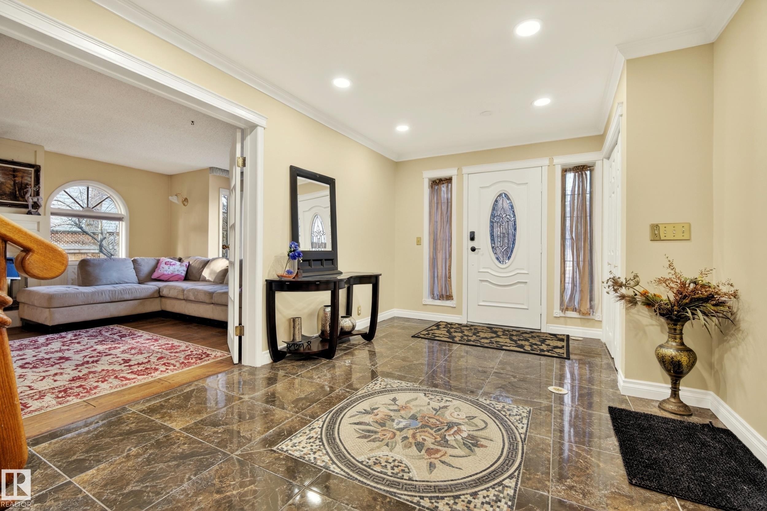 Grand entryway featuring polished floor tiles with an intricate mosaic inlay, a white front door with an oval glass insert, and recessed lighting - 33 Glen Meadow Crescent, St. Albert, AB - Indoor Photo Showing Other Room
