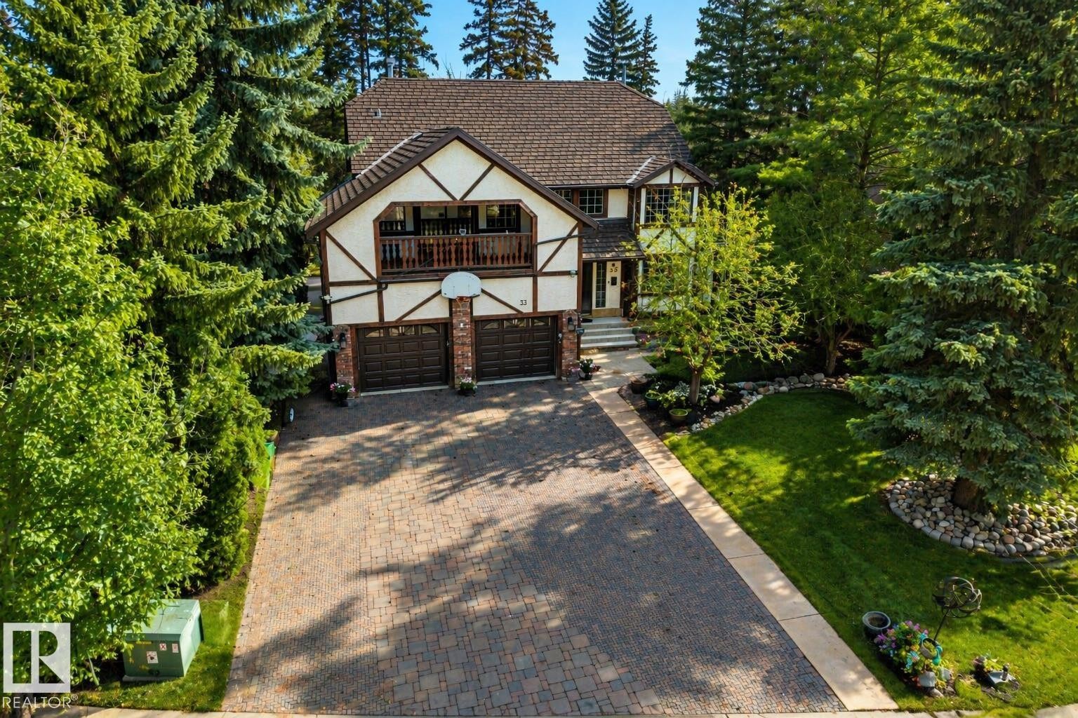 Tudor-style exterior featuring a prominent gabled roof and decorative half-timbering - 33 Glen Meadow Crescent, St. Albert, AB - Outdoor With Deck Patio Veranda