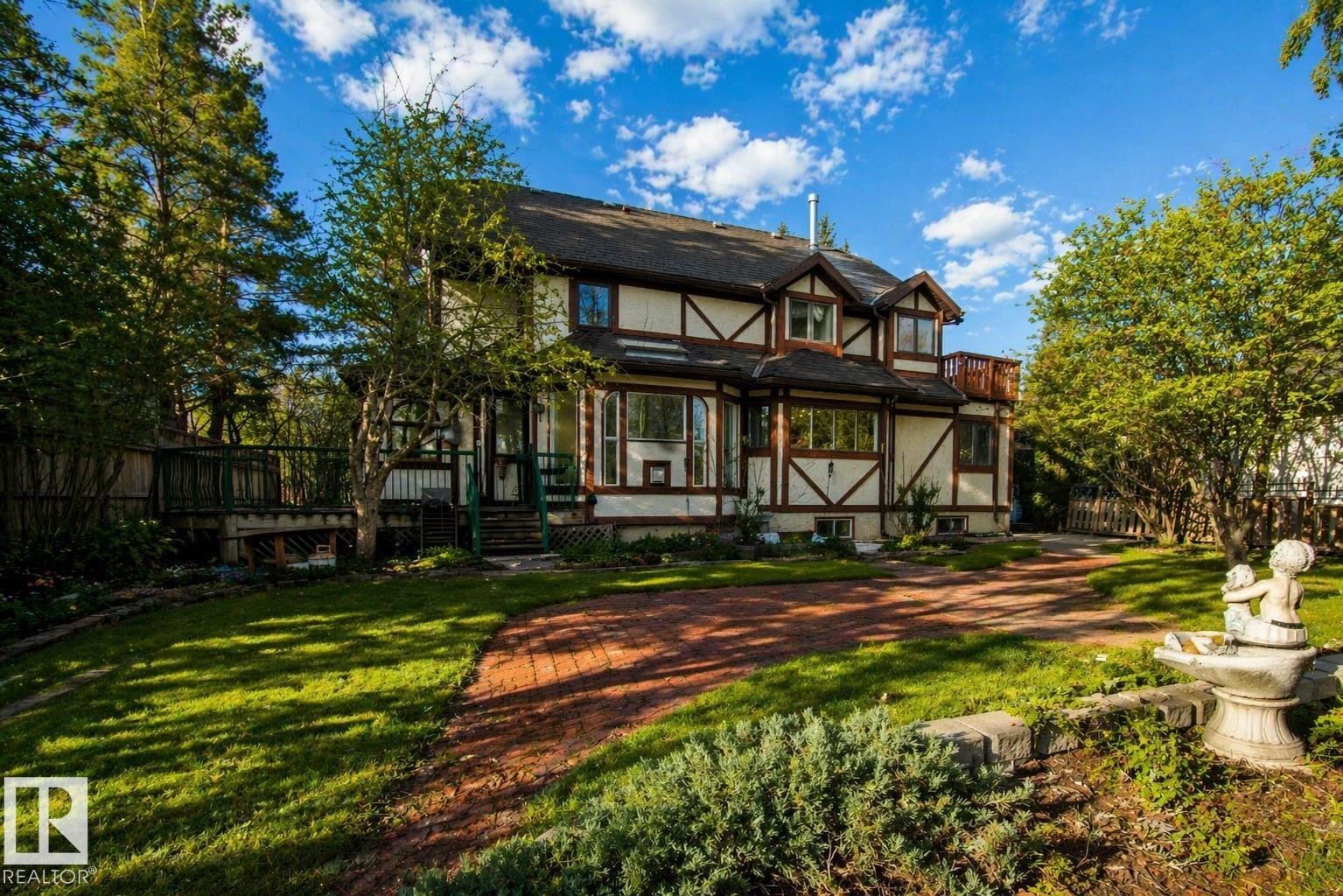 Tudor-style exterior with exposed timber framing and multiple bay windows - 33 Glen Meadow Crescent, St. Albert, AB - Outdoor With Deck Patio Veranda