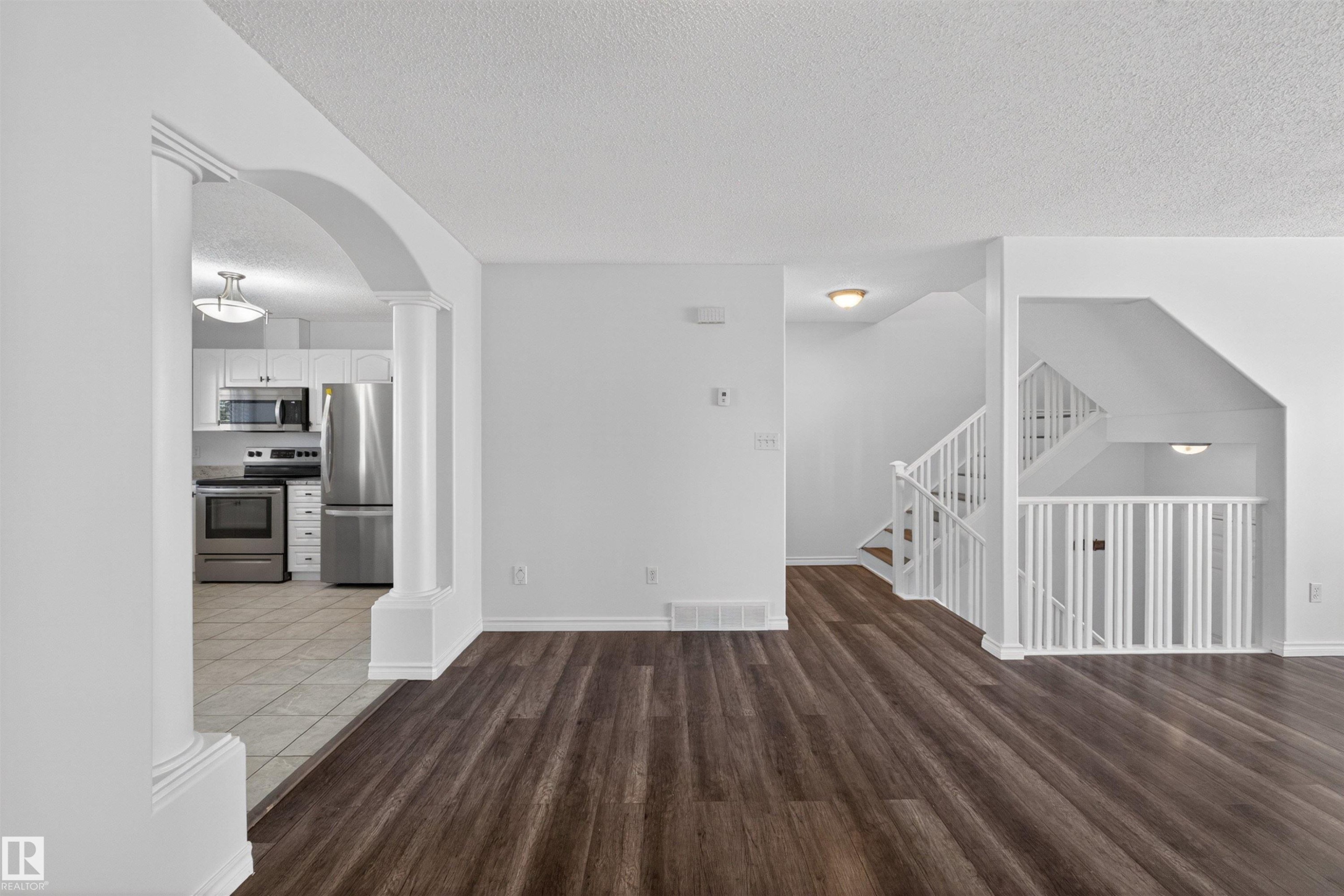 Interior featuring dark wood-finish flooring, white walls, and white trim - 6 1237 Carter Crest Road, Edmonton, AB