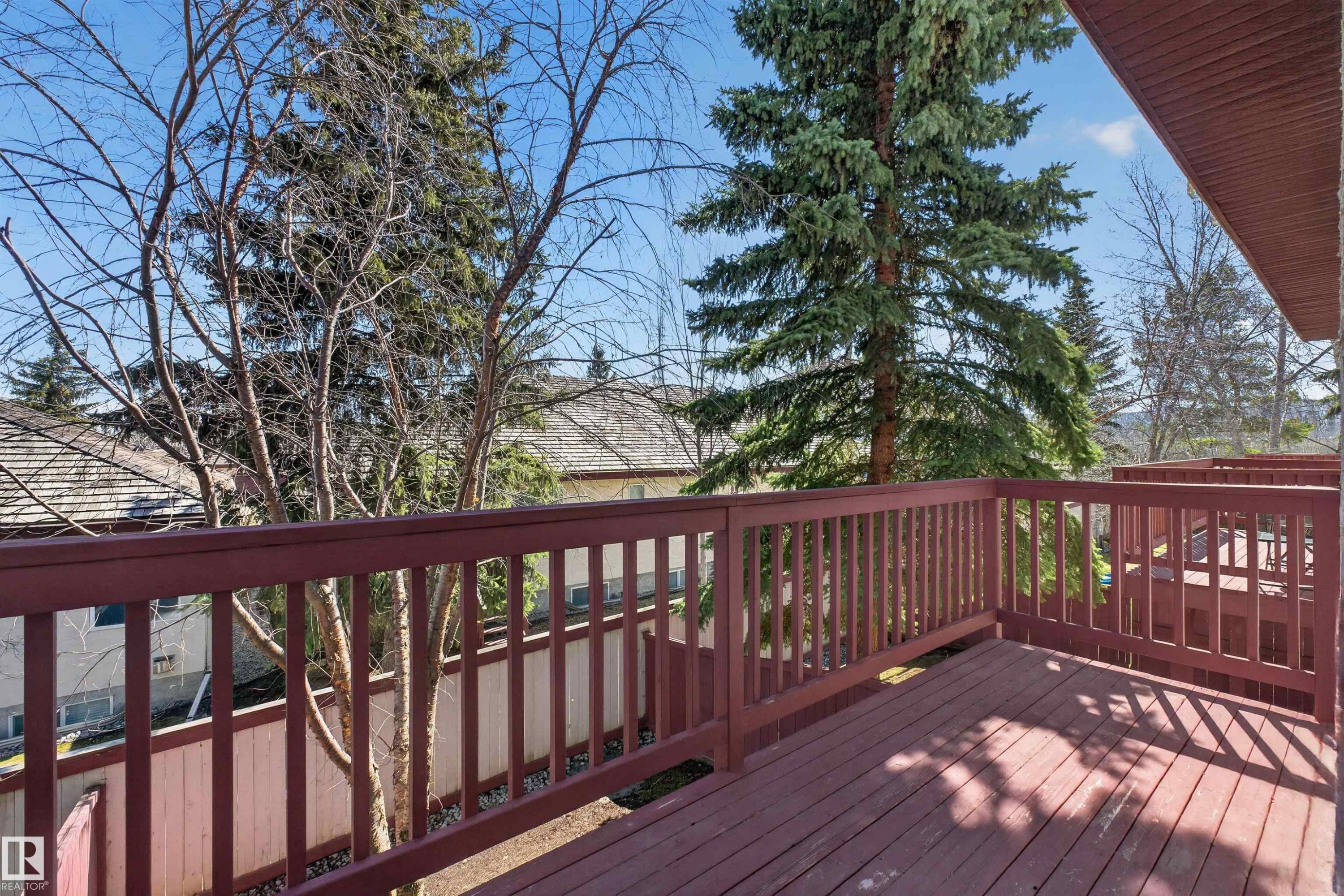 Expansive wooden deck featuring dark-stained wood flooring and matching railings - 6 1237 Carter Crest Road, Edmonton, AB