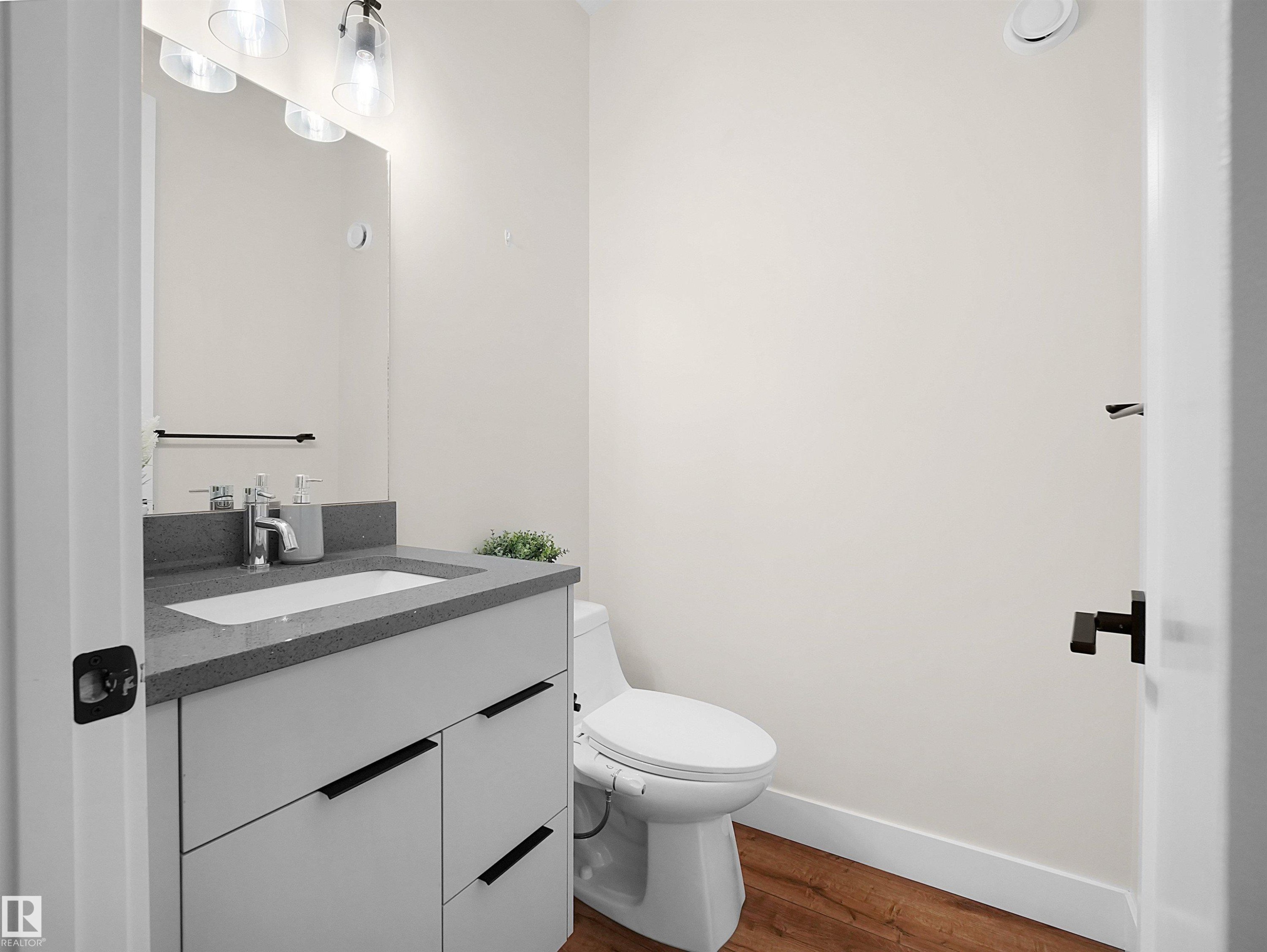 Modern bathroom vanity with a gray countertop, integrated sink, and contemporary faucet - 20827 130 Avenue Nw, Edmonton, AB - Indoor Photo Showing Bathroom