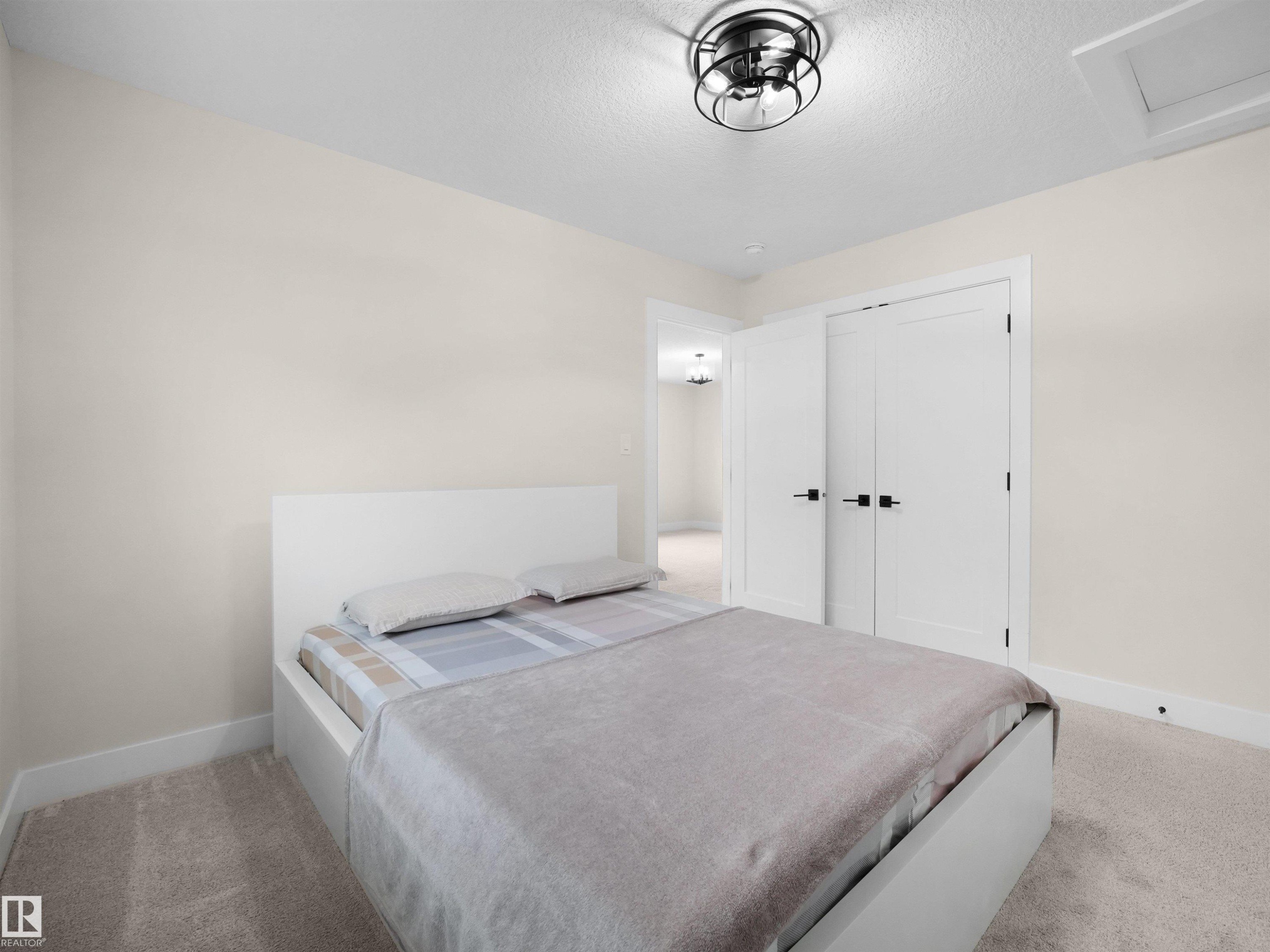 Light-colored walls complement plush carpeting - 20827 130 Avenue Nw, Edmonton, AB - Indoor Photo Showing Bedroom