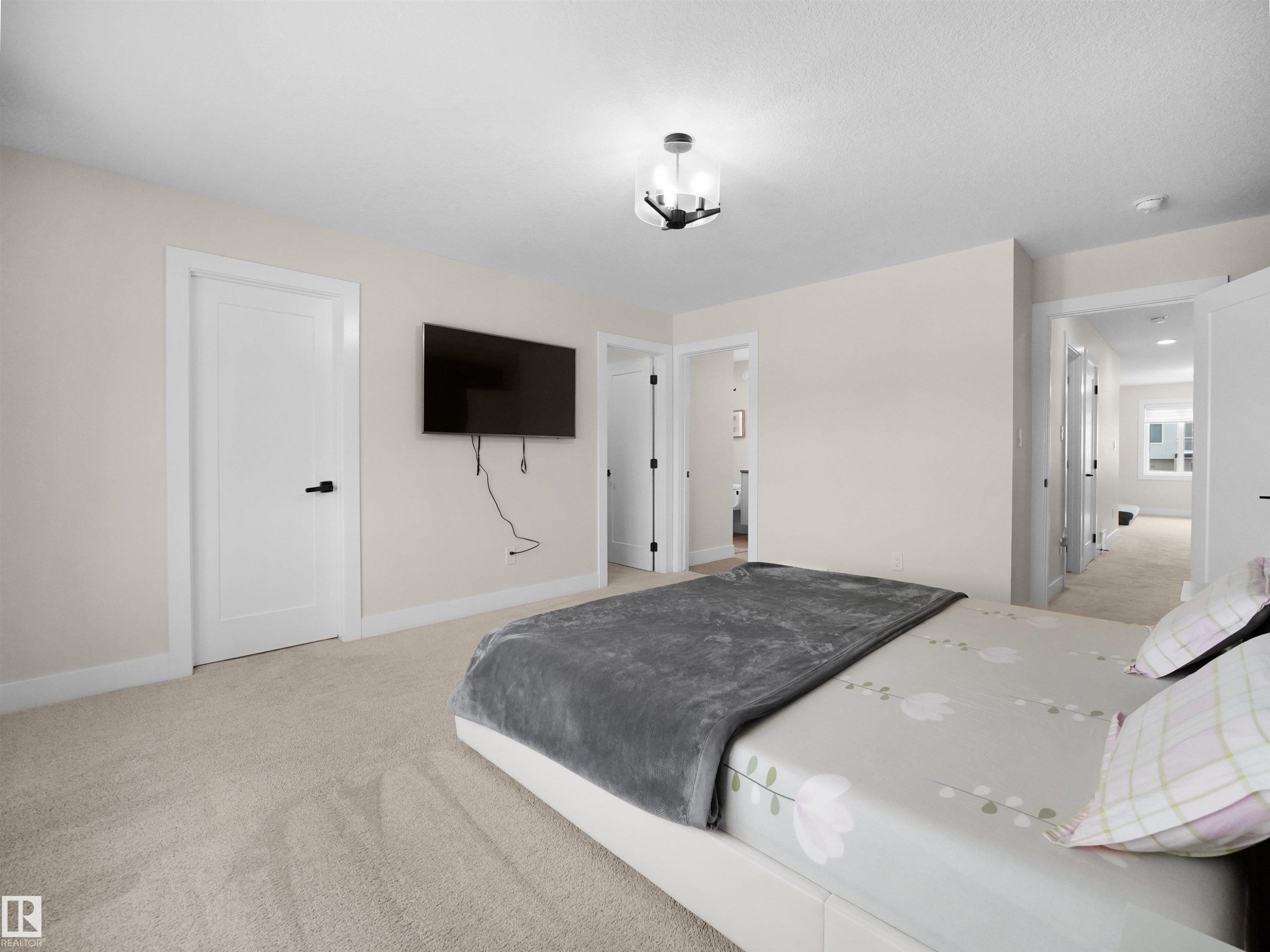 Bedroom featuring neutral-toned carpeting, white walls, and a contemporary semi-flush ceiling fixture - 20827 130 Avenue Nw, Edmonton, AB - Indoor Photo Showing Bedroom
