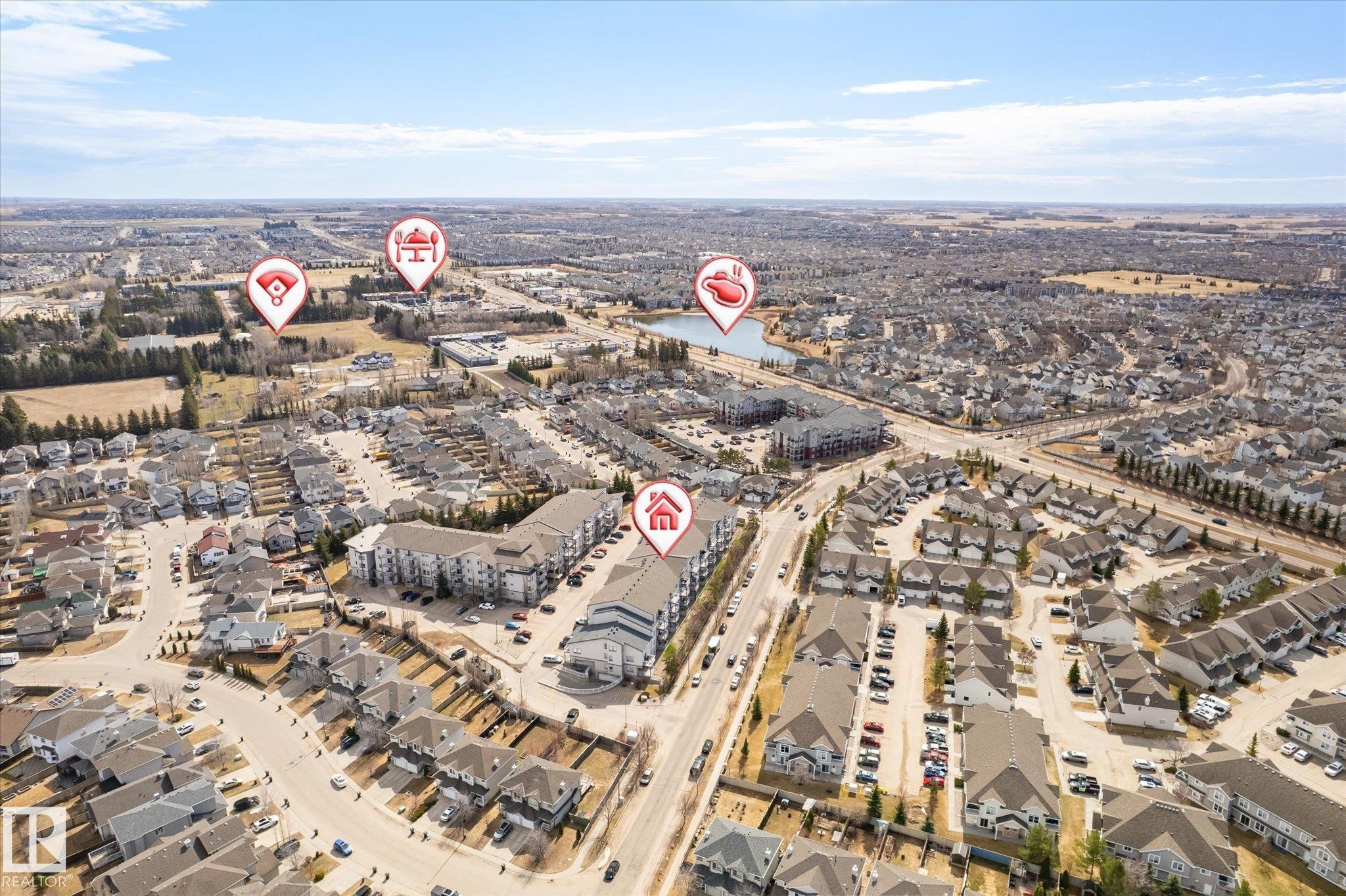 Aerial view showcasing a residential area with a prominent central thoroughfare - 203 155 Edwards Drive, Edmonton, AB - Outdoor With View