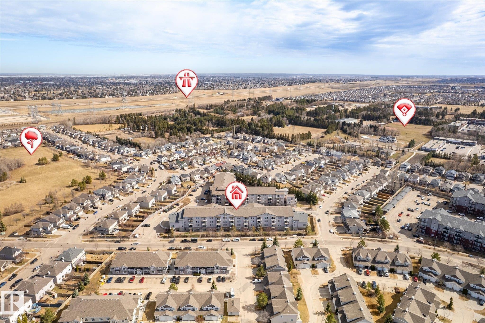 Aerial perspective showcasing a residential neighborhood with varied housing types - 203 155 Edwards Drive, Edmonton, AB - Outdoor With View