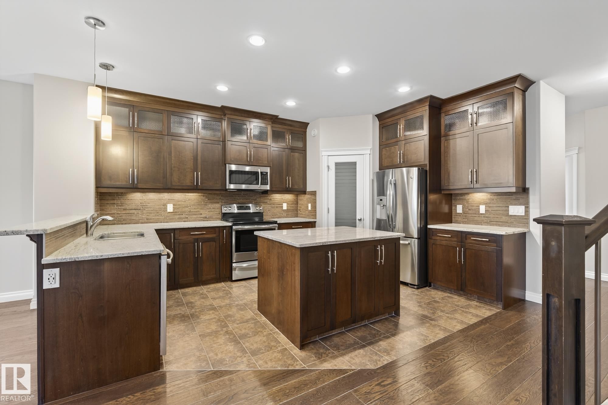 Kitchen featuring wood-finish cabinetry, stainless steel appliances, granite countertops, tile backsplash, and recessed lighting - 11106 76 Avenue, Edmonton, AB - Indoor Photo Showing Kitchen With Stainless Steel Kitchen With Double Sink With Upgraded Kitchen