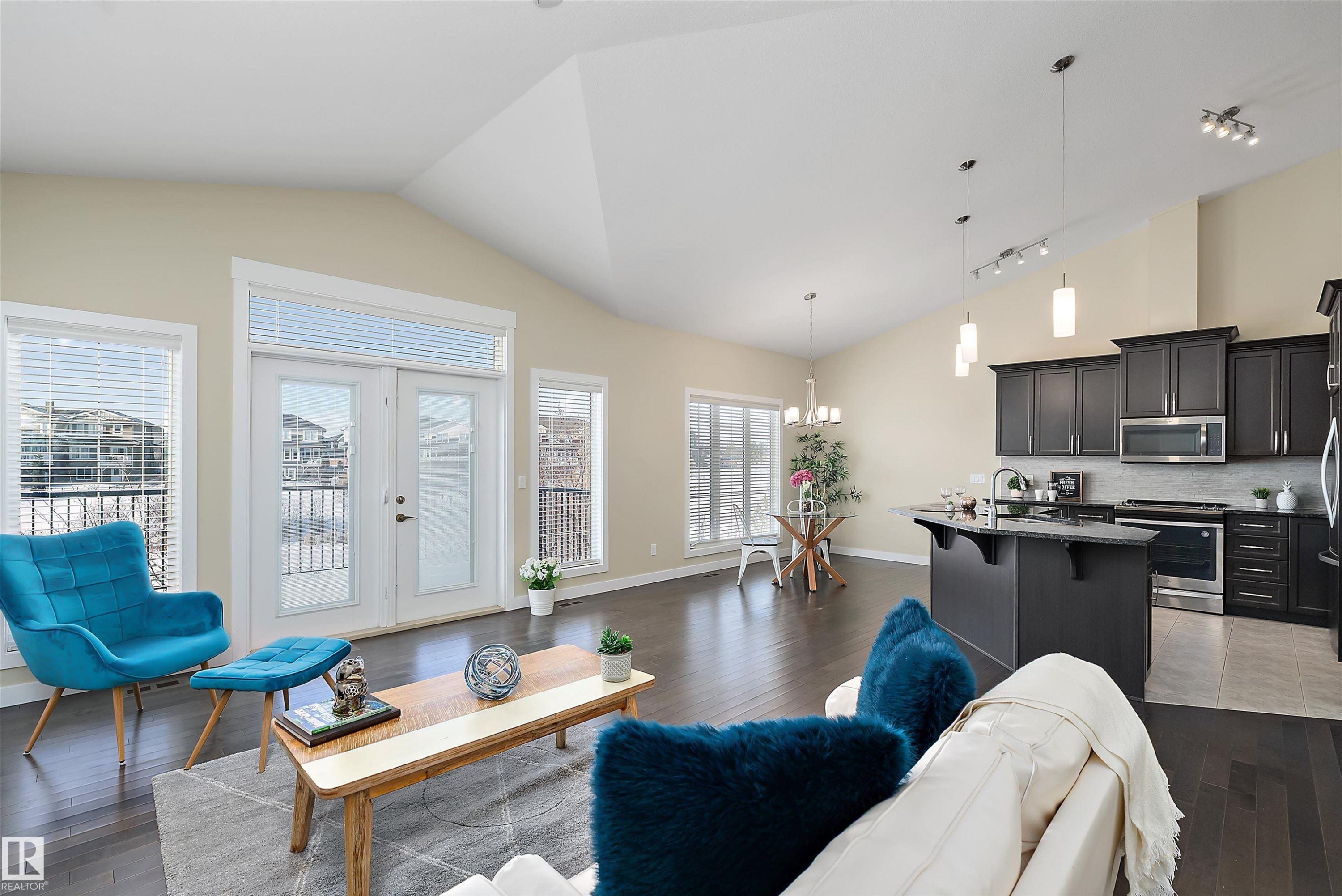 Vaulted ceiling great room featuring dark wood-finish flooring - 14 3090 Cameron Heights Way, Edmonton, AB - Indoor