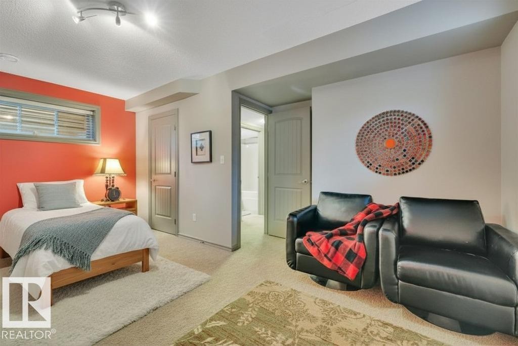 Large basement bedroom - virtually staged with bed - 1611 63 Street, Edmonton, AB - Indoor Photo Showing Bedroom