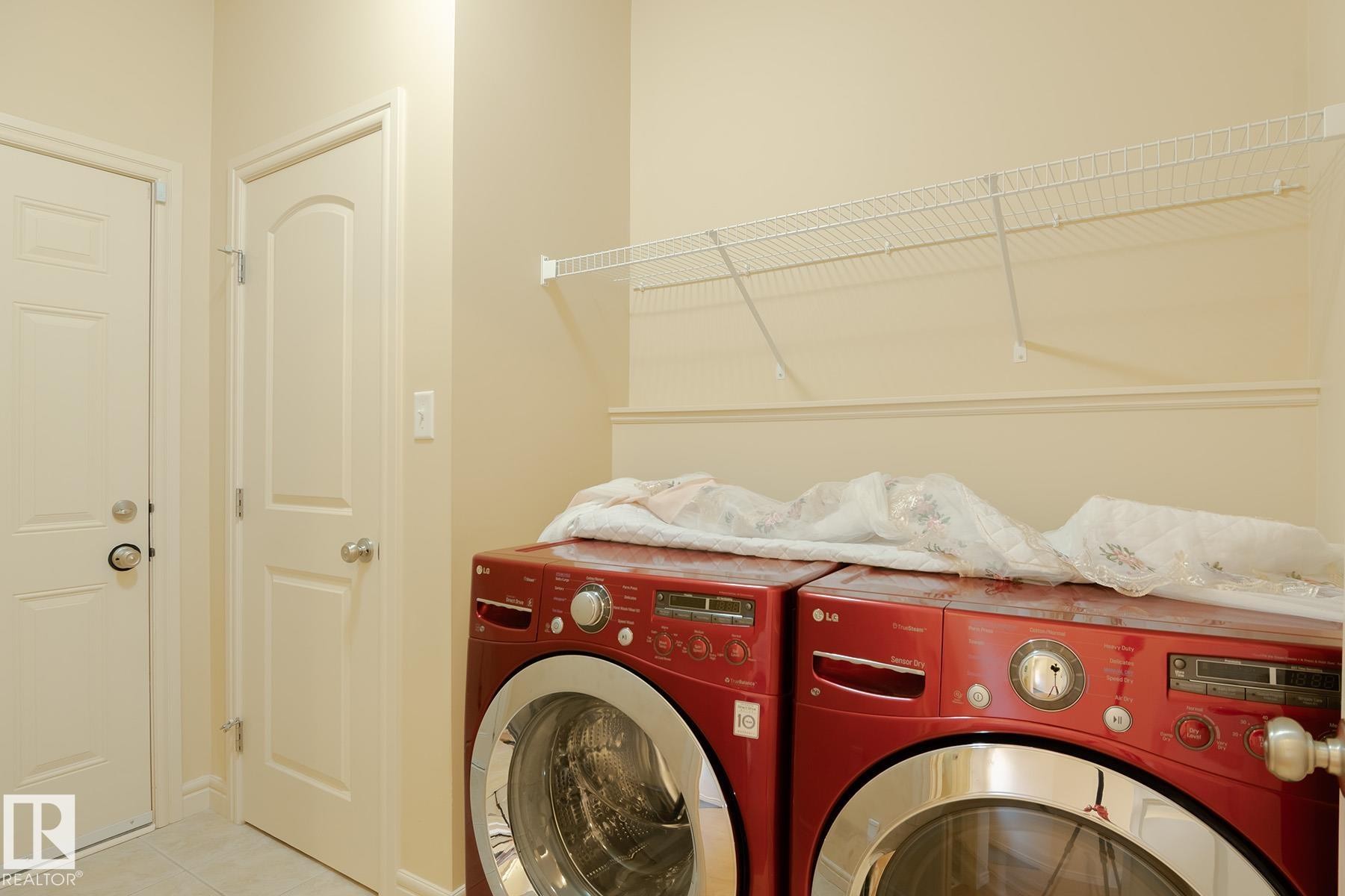Dedicated laundry area featuring a white wire shelving unit for storage and a neutral color palette - 7426 Getty Way, Edmonton, AB - Indoor Photo Showing Laundry Room